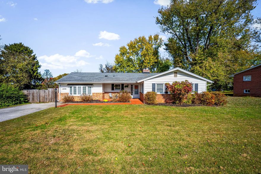 Tucked away on a quiet dead-end street and set up on a hill, this charming one-level mid-century rancher offers a peaceful, private setting while still being within walking distance of many local favorites. Enjoy the convenience of nearby spots including the library, park, Snoasis, Cuvino Trattoria, Edo Sushi, Taco Bravo, Cakes by Jason, and Uber Bagels. Outdoor enthusiasts will love being just moments from County Home Park, featuring a brand-new disc golf course, scenic walking trails, abundant wildlife, pickleball courts, a new sports complex, community garden plots, and the Historic County Almshouse Museum.

Situated on nearly half an acre, the property provides a spacious, fully fenced backyard and side yard—ideal for pets, and outdoor enjoyment. A pristine Trex deck creates the perfect space for dining and entertaining while shaded by mature crepe myrtles and surrounded by large container garden beds ready for herbs or vegetables. From the elevated deck, take in peaceful views of the yard and enjoy evenings around the stone firepit. Mature landscaping, including beautiful forsythia and hydrangeas, enhances the property, while frequent deer and bird sightings add to the natural charm. The home also features a welcoming covered brick front porch and a three-season sunroom with sliding doors that open fully to invite in fresh air and breezes.

Inside, the home offers the ease of single-level living with beautiful hardwood floors throughout. The open living and dining area is filled with natural light from two large bay windows and anchored by a classic brick wood-burning fireplace. The kitchen features granite countertops, stainless steel appliances, and a spacious walk-in pantry, while a dedicated laundry room adds everyday convenience. The primary bathroom has been updated, and the hall bathroom includes a bathtub.

Storage is plentiful throughout the home, including floor-to-ceiling storage behind sliding doors in the family room, a usable attic and crawlspace, and an outdoor storage shed for lawn equipment, gardening supplies, or bikes. The driveway provides parking for up to four vehicles.

The generous side yard sits on a separate parcel, offering exciting potential for future expansion such as a studio, home office, or additional living space.

Recent updates include a brand-new water heater (2026) and new thermostat (2025), along with a newer water pressure tank.