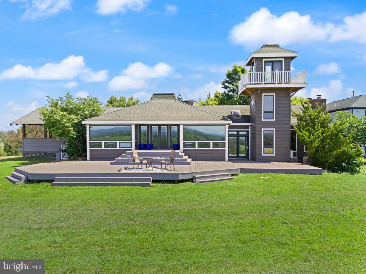 Welcome to 15192 Harrison Hill Lane, an extraordinary estate nestled on over 15 scenic acres in the heart of Leesburg, Virginia. This unique property features four distinct residences, offering unmatched potential for multigenerational living, income producing opportunities, or simply just a private oasis.
The Main Residence
Perched at the highest point of the property, the main home captures panoramic views of the Leesburg countryside. This 4 bedroom, 2.5 bath home features an open concept kitchen and dining area ideal for entertaining, and a unique watchtower that adds charm and functionality. Currently operating as a successful short term rental, it blends everyday comfort with strong income potential.
The Stone Tower
A striking work of 3 level European inspired architecture, this second residence showcases masterful stone craftsmanship with 20% quartz reinforced exterior walls and Category 4 storm rated windows. The mechanical, electrical, and plumbing (MEP) systems have already been roughed in, leaving this architectural gem just awaiting the final touches from its next visionary owner to complete a true masterpiece. Adjacent to the structure is a custom dug, nearly 18-foot-deep unfinished pool that could be finished or transformed into an underground event space or luxury retreat. In addition there's a designated spa area and completed stone gazebo with an outdoor fireplace offer elegant spaces for entertaining or peaceful relaxation.
The Barndominium Home
This modern two level residence features 2 bedrooms, 2.5 bathrooms, a spacious open concept main level ideal for entertaining, and its own scenic watchtower. The home also includes a large hangar, offering unique functionality for storage or creative use. Located beside three professionally lit pickleball courts, this home blends luxury living with exceptional recreational amenities.
The Guest Duplex
The fourth structure is a fully equipped, two level residence with independent apartment units on each floor, ideal for guests, extended family, or added rental income.
Just minutes from historic downtown Leesburg, award winning wineries, equestrian trails, and major commuter routes, this unique property offers exceptional lifestyle flexibility in one of Northern Virginia’s most sought after locations.
Don’t miss this rare opportunity to own a unique estate offering limitless potential, whether for personal enjoyment, multigenerational living, or income producing ventures, all within minutes of downtown Leesburg. Schedule your private tour today and experience the unmatched lifestyle that 15192 Harrison Hill Lane has to offer.