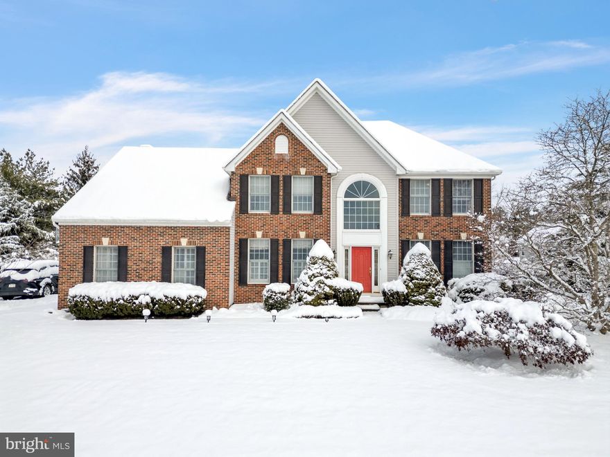 Nestled within the tranquil enclave of Newtown Meadows, set on the doorstep of Tyler State Park, this distinguished Colonial-style residence offers an exceptional balance of timeless elegance, impeccable outdoor living, and modern comfort. Featuring 4 bedrooms, 2 full bathrooms and 2 half bathrooms, the home is thoughtfully designed for those who value functionality and refined living. A towering two-story foyer creates a dramatic and welcoming first impression, immediately revealing an interior cascading with natural light throughout. Rich hardwood flooring flows seamlessly through the main living areas, enhancing the home’s warmth and architectural continuity. Find the living room with plantation shutters offering character and a private study provides an ideal work-from-home environment. The gourmet kitchen serves as the heart of the home, featuring upgraded countertops, a generous center island, gas burning cooktop, double wall ovens and a well-appointed pantry, ideal for both everyday living and entertaining. The kitchen flows effortlessly into the breakfast area and family room, creating a cohesive and inviting space for gathering. An elegant formal dining room offers the perfect setting for special occasions, while the adjacent family room, anchored by a beautiful fireplace, provides a comfortable retreat for relaxed evenings. The second level features a hallway bathroom with a double vanity and 4 generously sized bedroom. Find the primary bedroom suite to be a  true sanctuary, highlighted by a vaulted ceiling, a spacious sitting area, and two walk-in closets. The spa-like primary bath features a soaking tub and separate stall shower, creating a serene retreat for rest and rejuvenation. Additional flexible living space continues in the finished basement, offering endless possibilities for a media room, fitness area, playroom, or home office; also sporting a half bath. The fully fenced backyard features a beautiful stone patio, perfect for outdoor entertaining, along with a dedicated vegetable garden and a level yard ideal for recreation or quiet enjoyment. Residents of Newtown Meadows enjoy access to meticulously maintained common areas and a scenic walking and jogging path, all while being moments from the trails, open space, and natural beauty of Tyler State Park, offering a rare combination of neighborhood living and an outdoor lifestyle. Ideally located just minutes from the shops and dining destinations of Newtown, this exceptional home offers more than just a residence, it presents a lifestyle defined by comfort, elegance, natural beauty, and community.