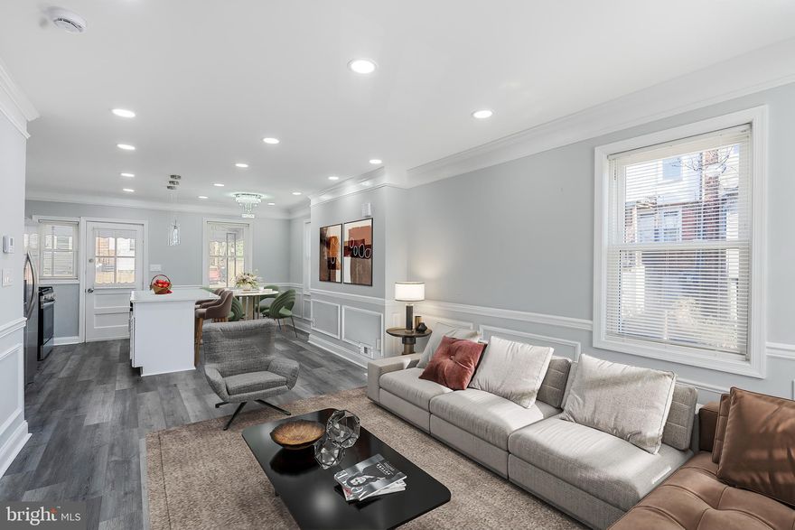 Welcome to this fully renovated end-of-group rowhome, offering modern finishes, stylish upgrades, and bright, open living spaces throughout. Enjoy your morning coffee on the covered front porch before stepping inside to beautifully updated interiors. As you enter, you’re greeted by LVP flooring, recessed lighting, crown molding, and chair rail, all adding to the home’s sophisticated charm. The open and bright living room is perfect for hosting guests, while the adjoining dining area creates an ideal space to wine and dine in style. The spacious kitchen is a showstopper, featuring quartz countertops, stainless steel appliances, abundant cabinetry, ample prep space, and modern lighting that elevates the entire space. Upstairs, you’ll find a spacious primary bedroom, along with two additional bedrooms and a beautifully updated full bathroom showcasing a custom tile surround tub/shower combo, perfect for unwinding after a long day. The fully finished lower level offers incredible flexibility with a rec room, a laundry area with extra storage, an additional bedroom, and a full bathroom complete with a large tiled walk-in shower. Outside, enjoy summer BBQs in the fenced yard, and never stress about parking with your own rear parking pad. Conveniently located near Reisterstown Road, Park Heights Avenue, and Cold Spring Lane, this home offers easy access to shopping, dining, and major commuter routes. Move right in and enjoy the perfect blend of modern updates, comfort, and convenience, schedule your showing today!