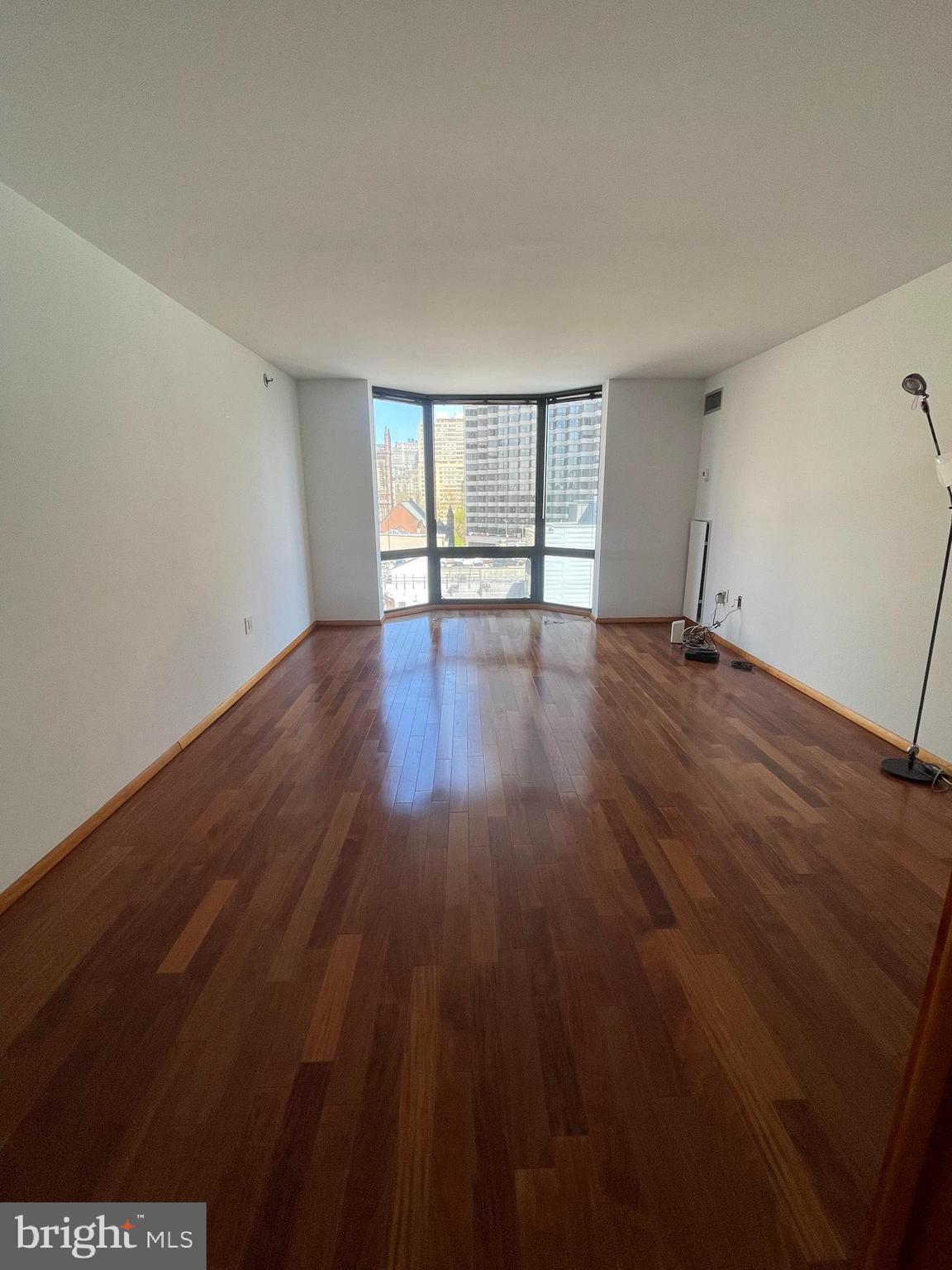 Beautifully updated one bedroom with Center City views at Wanamaker House. This home features floor-to-ceiling bay windows in the great room and bedroom and wood floors throughout. The great room is beaming with natural light and has ample space for living, dining, and entertaining. Open to the great room is the fully updated kitchen with sleek white cabinetry, dark solid surface countertops, white tile backsplash, stainless steel appliances, and a tile floor. The bedroom is generously sized and enjoys an adjacent walk-in closet with built-ins and a modern bathroom with white single vanity, glass enclosed tub shower, and white tilework throughout. The Wanamaker House is located one block from Rittenhouse Square and provides easy access to both Center City and University City; residents enjoy a 24-hour doorman, a seasonal rooftop pool, a fitness center, and a parking garage available for an additional fee (subject to availability). All common areas were recently renovated including the lobby, hallways, meeting room, amenity lounge, and fitness center, designed by world- renowned architect Cecil Baker.