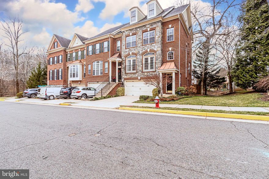 RARELY AVAILABLE!!! Stunning stone front, end unit townhome that is perfectly situated on a beautiful lot tucked in the back of the Aspen Hill community, within walking distance to Indian Run Stream Valley Park and path.   This home is offered with an extended gourmet kitchen, hardwoods on the lower and main levels, crown molding throughout, and recessed lighting. The extended gourmet kitchen is an original upgrade from the builder that is nicely appointed with cherry cabinets that touch the ceilings, upgraded backsplash, built-in kitchen table and a butler’s pantry.   The home boasts of high ceilings and oversized windows that are sure to make morning coffee that much more relaxing as the sunrise is pouring into the room.    The family room, equipped with a gas fireplace, is perfect for unwinding with a glass of wine and a book on those cold winter nights. The spacious lower level has built-ins, perfect for storing those games for game night on the private patio.    If you are a commuter this home is perfect for you! The bus stop on the corner will take you directly to The Pentagon! You can also easily access all points east and west via the close proximity to I-395. If you travel for work or for fun, Reagan National Airport is just a hop, skip and a jump away.    Absolute MUST SEE!!!