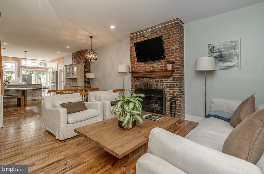 Welcome 615 S. Hancock St! Located on one of the most quintessential blocks in Queen Village, this home has all the character of an early 20th century home yet is ideal for modern city living. This 18 foot wide, recently updated rowhome boasts 3 bedrooms, 2.5 bathrooms, finished basement two fireplaces and two outdoor spaces. Enter into a light filled, open concept floor plan—the main living space anchored by a beautiful historic exposed brick fireplace and a large cased window.  A continuous flow carries you into the kitchen/dining area. This recently renovated kitchen features top-of-the-line KitchenAid appliances, quartz countertops, and ever-popular Clé tile backsplash. This open, airy kitchen leads you to a serene outdoor space, with impeccably maintained landscaping, perfect for entertaining friends or enjoying a quiet dinner al fresco. Follow switchback stairs to the finished basement, with a surplus of extra storage space currently setup as a bedroom. Upstairs you will find two large sun-drenched bedrooms with views of a quiet tree-lined street in the front and the idyllic outdoor space in the rear bedroom complete with a Juliet balcony. Separating these two bedrooms is an expansive bathroom with modern finishes, high-end decorator tile flooring, and a rain forest shower head. You will find a spectacular primary suite on the third level, with a gorgeous balcony overlooking a beautiful garden and cityscape views. New hardwood floors carry you to the updated primary bath, featuring a large Jacuzzi tub and oversized walk-in shower.  This home offers a quiet, tranquil retreat amongst one of the cities most popular neighborhoods. Located in Queen Village's heart and highly sought-after Meredith catchment, the best of Philadelphia living surrounds you. Just around the corner is bustling South Street.  A few blocks away, you'll find some of the best restaurants in town, such as Little Fish, Cry Baby Pasta, Neighborhood Ramen, and more.  Historic charm in a modern cityscape awaits you!