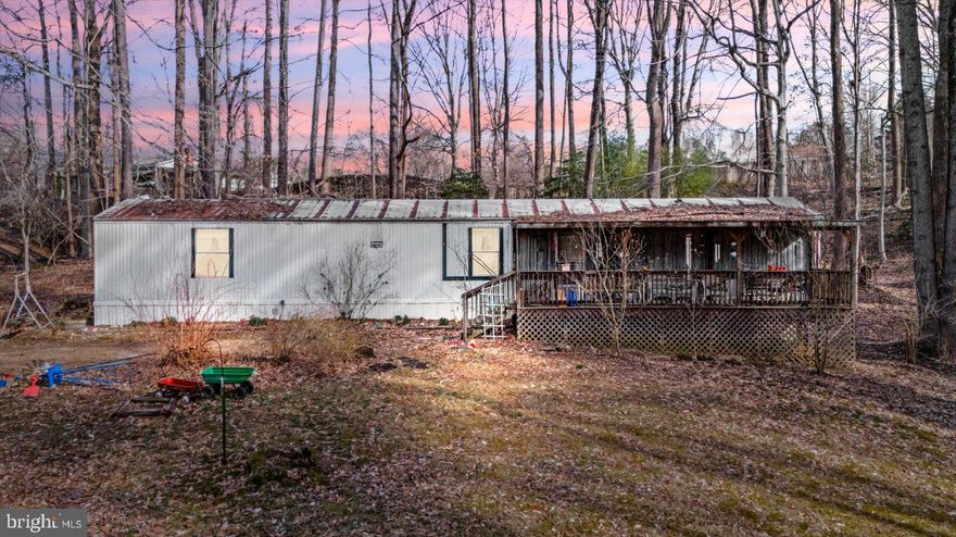 This property is the best of both worlds!! Just under 3 acres in a neighborhood, with an exemption to the HOA. Chicken coop, sheds, privacy and space are some of the features in this opportunity! Being in the Sealston area of King George, you are close enough to the city, without being enthralled in the hustle and bustle. 
A mobile home sits on the property, with the utilities in place.  There is a 3-bedroom, conventional septic system. You can choose to keep the mobile home on the property, or you can remove and build your own! This property has great potential and will go quickly! 
Note that with the home not being on a permanent foundation, this will have to be a land loan or cash deal.