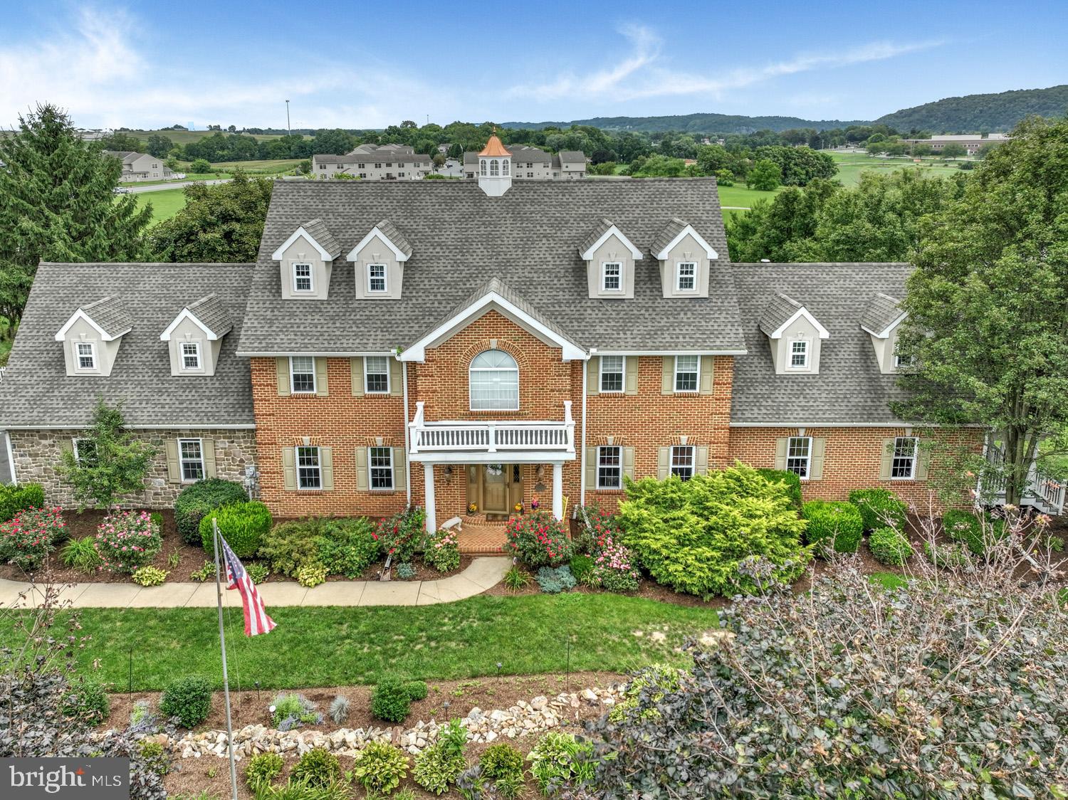 Exceptional 2 1/2 story, 8164 total square-foot home in Donegal schools built in 1995, boasting 6 bedrooms, 4 bathrooms, and two powder rooms. Step into the meticulously renovated kitchen, featuring a stunning 13-foot island with exquisite granite imported from India, ample cabinet space, 2 sinks and views overlooking the expansive 48’ x 13’ covered porch, inviting swimming pool, and expansive concrete patio. 1st floor laundry, large walk in pantry. Formal Dining Room, family room with fireplace, den and an additional 1st floor space as office or 1st floor bedroom. Second floor offers 4 bedrooms with a Primary bedroom owners dream of, with study area fireplace and large custom walk-in closets. Two additional bedrooms and bath on the 3rd floor. The full daylight walkout basement offers a second kitchen, large eating area, and game room, and outdoor kitchen, by the pool, perfect for entertaining large groups of family, friends, or business associates, or even possibly for use as a bed-and-breakfast. Enjoy the pond view with a fountain while relaxing in this picturesque setting. The property also includes an attached two-car garage, a detached three-car garage, and a one-car below-grade garage, grape arbors, garden area, greenhouse, and equipment shed. Additionally, there is a second house on the property being used for housing for a caretaker/gardener, built in 1858 with 1440 sq. ft., three bedrooms, and one and a half bathrooms. A must see 1.7 acre property. Contact us today for your personal tour.