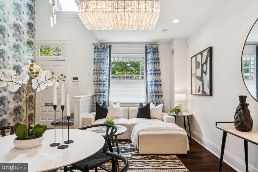 Four-story townhouse with elevator in a prime Rittenhouse Square location. This recently renovated property offers 2600+ SF of elevated living plus a basement with ample storage. Enter into a lovely foyer with a built-in bench and continue into the open kitchen/dining/sitting room with a dramatic double-height opening. The striking kitchen is outfitted with Wolf & Sub-Zero appliances, an oversized island with quartz countertops, and custom cabinetry. The 1st level is complete with a powder room and mudroom with custom built-ins. 

The 2nd level of this home features a south-facing facing living room  with a gas fireplace and custom-built-ins, including a wet bar with wine refrigeration and storage. A conveniently located powder room is just down the hall, and there is a laundry room with a full-sized washer, dryer, and utility sink. 

The 3rd level of this home is the Primary Suite, with a spacious bedroom, en-suite marble bathroom with double vanity sink, freestanding bathtub and glass-enclosed shower, plus a generously outfitted dressing room/walk-in wardrobe. Two additional bedrooms and a hall bathroom with a double vanity sink & bathtub/shower combo are located on the 4th level. The roof deck is accessed through the main staircase, offering exceptional views and a quiet place for a morning coffee or evening cocktail. 

It is located in the heart of the neighborhood, with easy access to the best restaurants, retail, and city conveniences. A short commute to Comcast/Xfinity, 30th Street Station, Penn & CHOP, and located in the Greenfield Elementary School Catchment. 3.5 years remain on the tax abatement.