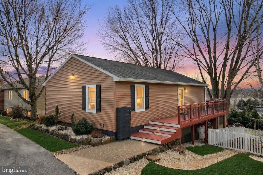 Discover a luxury lifestyle in this stunning Lake Meade residence. This beautifully renovated home boasts an open floor plan, seamlessly blending elegance and comfort. Step inside to find rich wood floors and a spacious kitchen featuring a central island, perfect for culinary enthusiasts. The inviting living area, dining area, and wrap around deck with a lake view sets the stage for intimate gatherings or serene evenings. Home features three generous bedrooms, a bonus room & a thoughtfully designed rec room. Sliding glass doors open to a covered porch leading to a great outdoor living area. Exterior boasts a stone patio, fenced in yard, and garden shed.  Nestled in a prestigious gated community, residents enjoy exclusive access to a wealth of amenities, including a community pool, tennis courts/ pickle ball, recreational center, and private lake access for boating, fishing, and water sports.  With a prime location just blocks from the Lake, this property is a haven for nature lovers and water enthusiasts alike. Great property!