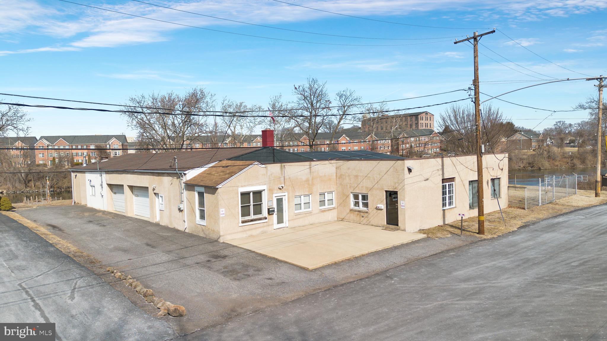 Prime Industrial Building For Sale along the Schuylkill River in Chester County, PA. Consider the plans on file for a multi-story condominium building with stunning views of the Schuylkill River just minutes from the revitalized town of Pottstown which offers easy access to local amenities, transportation and it's a growing community with a strong demand for modern housing! Envision “A brew for all seasons!” Unlock the potential of this unique building, ideal for a brewery. Situated in a high-visibility location, this property was designed for brewing operations, featuring expansive production space, high ceilings, and the ideal interior character tailored to craft beer, distilling, or food and beverage ventures.
This exceptional industrial property, located along the scenic Schuylkill River in Chester County, PA, offers a rare opportunity for the business owner. If you are seeking a water front location within North Coventry Township, over the bridge along the Schuylkill River look no further. The space and versatility of this property is limitless. Situated on a generous lot, this property features an expansive warehouse with high ceilings, multiple garages, private offices, reception area with a private entrance, and a robust infrastructure to support business operations. Many wonderful highlights await you at 57-59 Schuylkill Avenue. Public utilities, wood burning stove, year round usage, water front setting, breathtaking views and landscaping, neighbors a boat ramp, ball fields, hiking and biking trails, kayaking, within minutes of shops and municipal buildings. Nestled along the water’s edge, this breathtaking property offers a rare combination of natural beauty and expansive views stretching across the water, offering peaceful sunrises and golden sunsets that reflect beautifully off the surface. Picturesque bridge views await you in the rear of the property. The landscape is adorned with vibrant wildflowers that bloom throughout the seasons, creating a stunning backdrop of color and tranquility. The rear of the property is illuminated in the evening with lights that grab the local passerby’s attention. The ambiance is irreplaceable, giving your future customers a place to kick back and relax with live music and house made brews. Convenient access to major highways, including Route 422, Route 724, and the Pennsylvania Turnpike, the property ensures seamless transportation and distribution capabilities. The riverfront setting offers a unique work environment, natural setting and so much potential. Bring your vision and your dream to 57-59 Schuylkill Avenue!
Whether you're looking to invest in a prime industrial asset, or repurpose the space for a new vision, this property presents an outstanding opportunity in a growing economic corridor in a prime location. Schedule a private tour today!