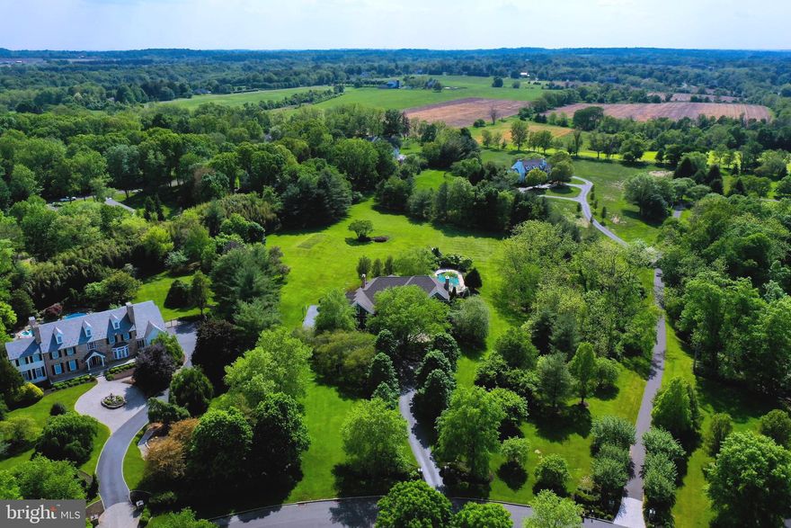 The Pinnacle of Weatherfield located on undoubtedly one of the most pristine  lots in the highly sought after "Preserve" section of Weatherfield in Upper Makefield Buck County on 4.5acres of beautifully manicured grounds. The home was renovated extensively in 2018-19 including entire main level, basement, and master suite. The thoughtfulness in design shines through in the ultra modern country style kitchen featuring rustic contemporary Slate Flagstone flooring, SubZero built-in Refrigerator/Freezer, SubZero under counter double refrigerator drawers, Wolf Range, Wolf Double Wall Oven, 2 Miele Dishwashers, and Leathered Granite countertops. The open kitchen floor plan leads to living room with fireplace and Knotty Elder floors and wide open eating area bookended by a cozy covered patio area to enjoy morning coffee and new multi-tier deck looking over the large pool area and beautiful landscapes. Main level features beautiful center hall encompassed by Hardwood Cherry and Oak flooring leading to large formal living room, updated half bath, formal dining room and beautiful office/study/librbary with expansive built in shelving and cabinets.. Main level also features a side office/ possible 6th bedroom with full bathroom beside it. Upper level features Main Suite with dual walk-in closets that feature ultra modern built-in storage, sunlit sitting area, and elegantly updated main bathroom featuring Marble floor, tile, and finishes. 2nd, 3rd, and 4th bedrooms all en-suite with full bathrooms. There is a very large finished room next to the 5th upper level bedroom above garages currently used as a playroom but could easily be a 6th bedroom the size of an apartment on the upper level. Basement is ideal for entertaining and has also been refinished featuring wet bar with pool table on one side, a separate game room/home gym/pay room, and big living area with full bathroom perfect for pool guests with walk out to pool area. Pool is saltwater and systems have all been replaced recently or meticulously maintained. Pool also features large hot tub and entire pool was all refurbished in 2013. Previous owners also did stucco with hardi plank restoration and replaced roof system in 2013 with 50 year shingles. Along with all the major interior  renovations in 2018, exterior improvements include new exterior stone facade, driveway entry pillars to match facade, driveway pavers, and backyard pavers. Deck was just redone in 2024. Many homes are well cared for but few are as thoughtfully maintained and as worry free as this home will offer its next owners.