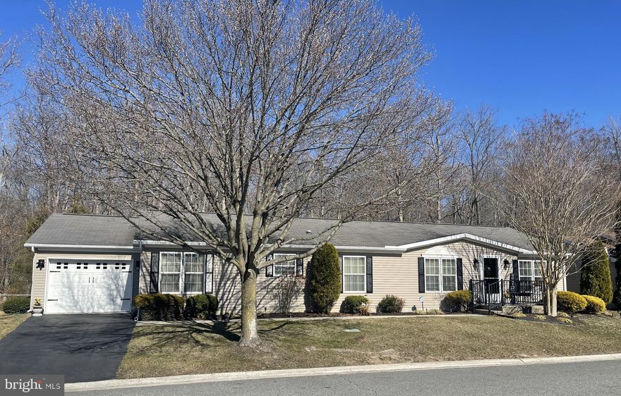 Price Reduced - Seller Motivated!   Beautifully updated and meticulously maintained, this is one of the largest homes in Wild Meadows.  Home is on a premium lot and one of the few that backs to woods allowing you to enjoy nature and privacy.  This home has a large primary bedroom with huge ensuite bathroom, two additional bedrooms, second full bathroom, Laundry Room with utility sink, Living Room, Dining Room, Breakfast Nook and a large Family Room with a gas fireplace that  looks out to your back deck.  You also have a large garage that has an extension for  additional storage and pull down stairs for more storage in the attic.   The seller has updated the kitchen with all new stainless steel appliances, new  washer and dryer, new floor in the primary bathroom, all new light /ceiling fan fixtures and new faucets and cabinet hardware throughout the home.  Live a carefree life and enjoy all the amenities that Wild Meadows has to offer!  The Monthly land lease current owner pays is one of the lowest at $751  and includes all lawn care, snow removal, community pool, club house with a fitness center, hot tub, library, craft room and activities such as bocce ball, shuffleboard, billiards, horseshoes, community events and more!  Conveniently located close to shopping, hospitals, Dover Raceway & Casino, historic Dover and a short trip to Delaware beaches and Ocean City.  You also have quick access to Route 1 making easy travel to PA, NY and DC airports.     This gorgeous home is move in ready, schedule your tour today!