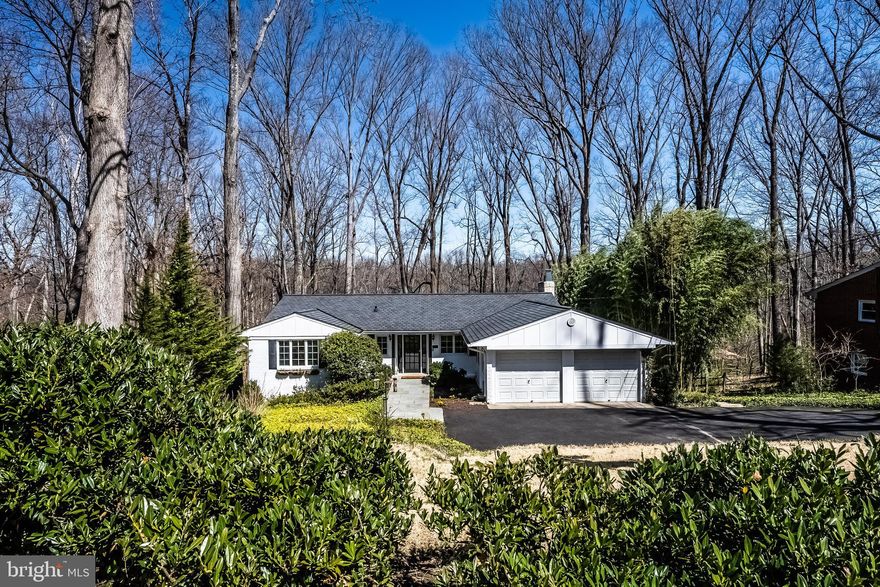 INCREDIBLE OPPORTUNITY!  Wonderful curb appeal here plus a full lower level walkout and wait until you see the VIEW!!  Unbelieveable 1/2 acre, private view overlooking parkland and Accotink Creek!  This is nature's paradise!  Daffodils and periwinkle greet you as you make your way to the front door.  Upon entering the welcoming and light filled foyer, you'll notice how  special this home is.  The kitchen is off to the right with a window overlooking the front walkway.  Features include granite counters, tiled backsplash, a gas cooktop, Bosch stainless dishwasher, built-in oven, built-in microwave and a stainless French door refrigerator with a instaview door in door (2023).   A tiled and mirrored space creates a mini-bar/prep area.  There is also under cabinet lighting.   Off of the kitchen is the dining room with a newer sliding glass door that overlooks the side yard.  Proceeding straight ahead from the foyer, you'll enter the  22x13' living room.   What a SPECTACULAR view overlooking the back yard and beyond!!  A gas fireplace and a custom, mirrored wall add to the ambiance here.  Opposite the fireplace are double doors that open to bedroom 3, or a study, or the perfect place for a piano, as the owner had it arranged.  Bedroom #3 includes a walk-in closet.  Down the bedroom hallway are 2 other bedrooms.  Bedroom #2 also has a walk-in closet.  The primary bedroom has double closets, a ceiling fan and a primary bath with a shower and a good sized linen closet.  A second bathroom is in the hallway.  Access to the attic is also in the hallway.   Heading to the lower level you'll find a 37x13' Family Room and a wood burning fireplace insert.  This room easily accommodates the pool table, which conveys,  and there is still plenty of room for gatherings!  Please note the beautiful, custom wainscotting here!  Off of the family room is a 20x20' deck.  This is the ideal place for outdoor entertaining and relaxing!  The azaleas are popping now! During the later summer, the back yard will be awash in shades of blue - about 70 blue hydrangeas - GORGEOUS!!  The lower level also includes a bedroom "wing".  Bedroom #4, with a ceiling fan and carpet, has a walk in closet.  A 15x12 "den" or bedroom #5 features parquet floors.  (The window sill in the den/bedroom #5 is at a 45" height, and per the county, the sill should not be higher than 44" to be classified as a bedroom. )   There is a fully remodeled bathroom #3 on this level.  Check out the wainscotting, slate flooring and tiles above the wainscotting - it is beautiful in shades of gray!    A very spacious utility room, which is about 23' long and a minimum of 10' wide, includes the HVAC (about 2016), water heater (8/21), a 2nd refrigerator (2022), a full size washer and dryer, a work bench and extra storage!
The garage is equipped with double doors and 2 garage door openers, however, the left side is divided for storage.  The walls can be easily removed.  There is a stackable washer and dryer here  (2/24) for those who do not want to go to the lower level.  The windows were replaced with Andersen Windows AND they were enlarged from the original windows.  The seller worked diligently to find someone who could "chink" the brick to allow for larger windows!  The roof was replaced with architectural shingles (about 10 years?).   Driveway repaved within past 3 years.   This home has been lovingly cared for.   What an incredible opportunity to get a home like this with a knock out view!!
Cinch Home Warrenty conveys.