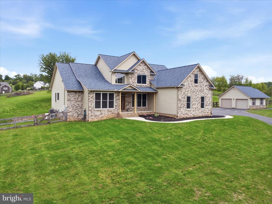 Country Living Meets Modern Convenience! 

Welcome home to this custom built 2 story colonial with a partial brick front set on 4.59 scenic acres. This spacious home offers space, flexibility, and exceptional amenities. It boasts over 4,200 square feet including the basement, an open floor plan, and a dramatic two story family room with a stunning stone wood-burning fireplace. The kitchen is well-appointed with granite countertops, a large island, abundant cabinetry, and a bright breakfast area, all flowing seamlessly into the main living spaces. The main-level owner’s suite provides convenience and comfort with a walk-in closet and private bath. Formal living and dining rooms, a welcoming foyer, main-level laundry, and a half bath complete the first floor. Upstairs, you’ll find a loft overlooking the family room, 3 generously sized bedrooms and 2 full baths, offering plenty of room for all of your needs. The unfinished basement offers excellent potential, featuring a rough-in for a future bath, walkout access to the exterior, and direct access to the garage. A French drain system and waterproofing provide added protection. Car enthusiasts and hobbyists will appreciate the 3-car attached garage plus an additional 2 car detached garage with workshop or hobby/music space - complete with electric and sound- proofing. The outdoor setting is equally impressive with a fenced yard, patio with pergola, chicken coop, play equipment, and a wood shed. Across the road you will enjoy the view of agricultural land and all of the wildlife that call this area home.  This owner has gone above and beyond with thoughtful upgrades and proactive planning to avoid any potential needs in the future.  Some of the highlights include a sand mound septic system (pumped and certified in 2024), owned 1,000 gallon buried propane tank, 200-amp service with 100-amp subpanel in the garage, and a generator. Major updates include roof (2025), HVAC (2023, 2-zone with app control), water heater (2023), windows (2023), water treatment system with reverse osmosis/UV/acid neutralizer (2020), radon system (2020), fresh paint (2026), and recently updated carpeting (2026). This amazing home is only a few miles to the Maryland line and minutes to Codorus State Park and Lake Marburg. This is one you won’t want to miss!!!