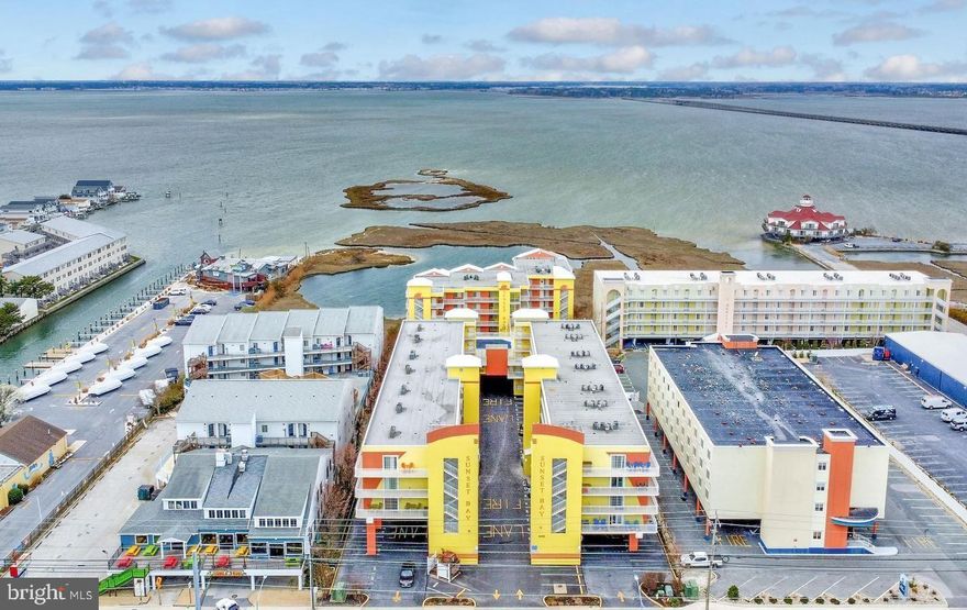 ***Currently only available for intermittent viewings between renters***. Incredible, fully furnished, 3 bedroom condo in sought after Sunset Bay!  Premium location in the complex overlooking the bay!  You'll love the layout and design which offer breathtaking views of the amazing bay sunset from the primary bedroom, living room, kitchen, and balcony!  Other features include the large kitchen breakfast bar, great owners suite with balcony access & luxury bath , gas fireplace (needs to be connected), and newer trendy flooring!  Completely turn key with newer furniture and furnishings!  Great location along Coastal Hwy just seconds to the beach!  Located in one of Ocean City's most popular spots with a short walk to great restaurants, shops, and other fantastic attractions!  Terrific condo amenities include an outdoor pool, hot tub, fitness center, pier/dock, kayak storage, elevator, & more!  Extra parking in addition to the assigned space!  Terrific rental with 3BR/2FB units being highly sought after and harder to find!  Owners rent it out randomly to friends, relatives, through Airbnb, and others.