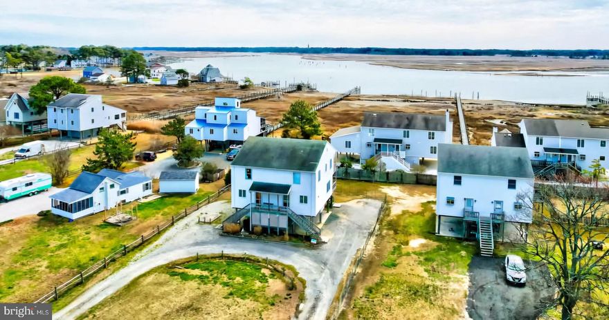 Island listing just in time for the 100th Annual Pony Swim! Located near the action on Pony Swim Lane! This lovely updated duplex is a beauty with 2 large bedrooms, 2.5 baths and upper and lower full decks overlooking Assateague Channel! Great view of the lighthouse and more! Parking space underneath plus a large yard... Selling mostly furnished and equipped, too!