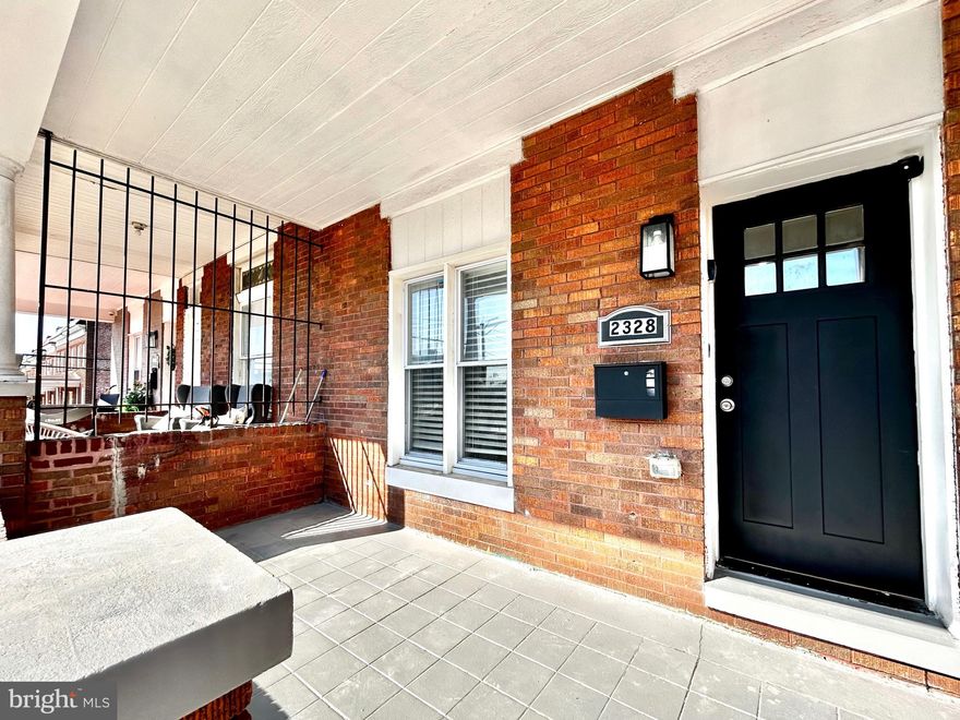 Welcome to this beautifully renovated porch-front brick rowhome offering three finished levels of modern living in Baltimore, including 1,362 sq ft of above-grade living space plus a finished lower level providing additional flexible living area. This spacious 4-bedroom, 2-bath home blends classic charm with contemporary upgrades throughout.

Step inside to an open-concept main level featuring recessed lighting, wide plank flooring, and an expansive living and dining area ideal for everyday living and entertaining. The chef’s kitchen showcases white cabinetry, quartz countertops, stainless steel appliances, custom backsplash, and a large center island with sink and modern black fixtures, providing both style and functionality.

Upstairs you’ll find generously sized bedrooms filled with natural light and updated finishes. The modern bathrooms feature sleek vanities, designer tile work, and contemporary black and white accents creating a clean, sophisticated look.

The finished lower level offers additional living space perfect for a recreation room, guest suite, home office, or entertainment area. A dedicated laundry area with washer and dryer adds everyday convenience.

Outside, enjoy the classic Baltimore porch-front exterior and the added value of a rear parking pad providing convenient off-street parking. Recent upgrades include updated electric, plumbing, and HVAC systems, and a new roof replaced within the last 5 years, delivering peace of mind for the next homeowner.

Located just minutes from downtown Baltimore, major commuter routes, shopping, and dining, this move-in ready home offers modern living at an exceptional value.
