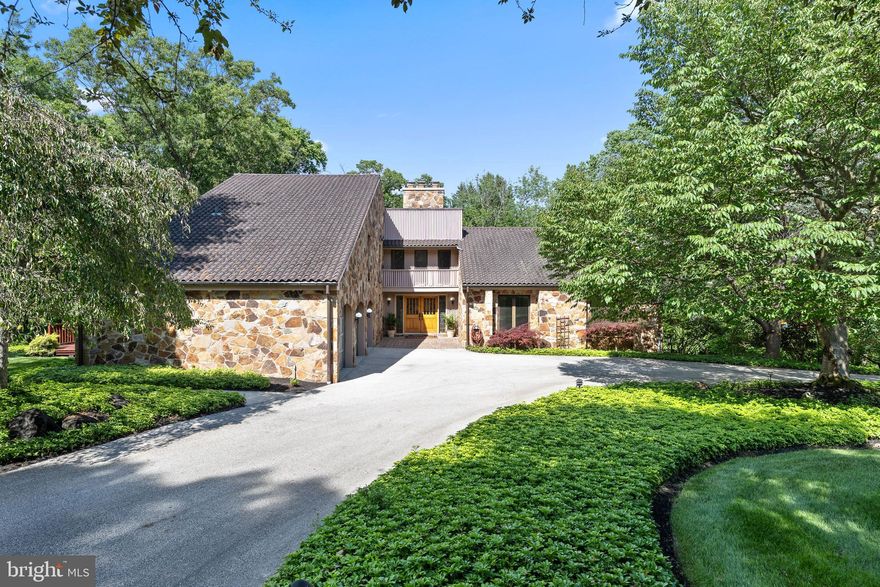 Welcome to 2228 East Deerfield Drive. Located in the heart of Rose Tree Media School District in the luxurious Springton Estates neighborhood, this stunning 5 bedroom, 3 full and 2 half bathroom stone contemporary home boasts stunning water views from every floor. Situated on a quiet tree-lined street and backing up to the Springton Reservoir, this home is a tranquil retreat just minutes from the bustling boro of Media. 

Approaching the home you are greeted by a stately double entrance driveway, mature trees, and a beautifully landscaped front yard that leads to the main entrance and three-car garage. Stained glass double doors lead you inside the home and into the center hall foyer with an exposed stone wall. Here two large hall closets provide plenty of space for your guests' belongings, as well as a convenient powder room. 

The kitchen sits off to the left, featuring an abundance of solid wood cabinetry, granite countertops, large windows, and a butler’s pantry with desk seating. The attached dining space is large enough to fit any dining table and has glass doors that lead to the wrap-around deck for easy alfresco dining. The kitchen seamlessly flows into the family room adorned with vaulted ceilings, tall picture windows, and parquet flooring. This space could easily be transitioned to a formal dining room. The two-story stone fireplace is the focal point of the living room, highlighting the sloped wooden-clad ceilings, and drawing your eyes up to the skylight and catwalk above. Sliding glass doors in this space lead out onto the wrap-around deck for easy entertaining in the warmer months. 

Hardwood flooring leads you into the bedroom wing where the first primary bedroom awaits. Boasting plush carpeting, large windows, and plenty of space, this primary bedroom is home to a spacious walk-in closet with built-in shelving. The ensuite bathroom has been recently ADA outfitted with a walk-in shower, pedestal sink, tile flooring, and views of the reservoir beyond. Bedroom #2 on this level boasts hardwood floors and a large closet while bedroom #3 has plush carpeting and a walk-in closet, both enjoying the use of a full hall bathroom. 

The second story is home to the spacious second primary bedroom. Here you’ll find a large seating area, plush carpeting, tall windows, and built-in cabinets in addition to the oversized walk-in closet. The attached ensuite is covered in marble tiling and hosts a bidet, oversized glass-enclosed stall shower, jetted soaking tub, and dual vanities in addition to a convenient linen closet. Bedroom #5 is currently being used as an office space and features hardwood flooring and two oversized walk-in closets on either side of the room. 

The fully finished walk-out basement is the perfect entertaining space. The large living room area features ceramic tile flooring, a stone facade wood-burning fireplace, wood-slatted detailed work framing the ceiling, and a solid wood built-in full-service bar. Sliding glass doors in this area lead out onto the covered concrete patio with additional water views for cozy entertaining. The other side of this basement hosts a large flex space currently being used as a home office, storage rooms, and laundry room. A convenient powder room rounds out this level. 

This magnificent home is located within the award-winning Rose Tree Media School District and is close to some of the best private schools in the country. It is just a quick drive to Media Borough, West Chester, and the Main Line, all with an impressive array of upscale restaurants and shopping. Residents of this home enjoy close proximity to Ridley Creek State Park offering fishing, biking, running, and walking trails, as well as major highways and public transportation for easy commuting to Center City and the surrounding suburbs.