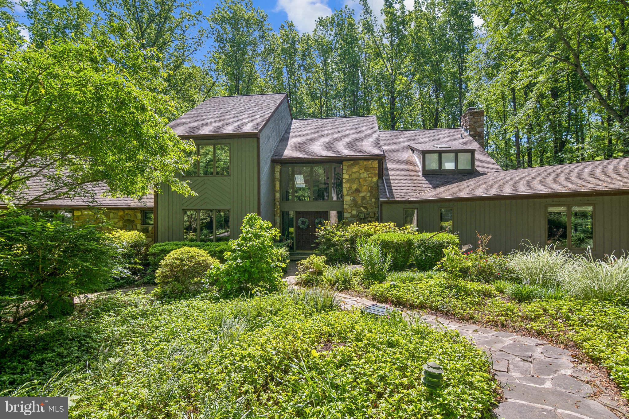 Improved Price, Ready for the new owner!! Set on over 2 acres of a countryside sanctuary, you'll be greeted by extensive perennials, textured ground cover and lush ornamentals trees.
The land is just one highlight of this incredible home. Whether you're a couple seeking room to grow or a family craving elevated functionality, this home adapts seamlessly to your lifestyle. The open concept floor plan starts with the expansive 2 story foyer. A formal dining room offers an elevated space for hosting and generous enough for a seating of 10. The kitchen is a true centerpiece, complete with double ovens, expansive granite countertops, a center island with an integrated cooktop and room for casual seating, stainless appliances and access to the gazebo and deck for additional entertaining, dining or a retreat!
The family gathering room with its wood burning fireplace will entertain friends for the holidays or provide serenity while you plot your next great adventure! Relax in the natural light that will drench the entire first floor or embrace the evening breeze on the outdoor deck during those warm summer nights. Perhaps soothe the stress in the hot tub if you are looking to relax, entertain, or simply enjoy some peaceful alone time, this hot tub is the perfect addition to your home. A true oasis, just steps from your door. The primary bedroom is furnished with another outdoor deck and an exquisite 4-piece ensuite featuring radiant heated floors, heated towel bar, dual vanities, soaking tub, walk-in shower and the spa-like luxury of a bidet. The oversized closet was expanded and fitted for more function.
Overlooking the great room, across the catwalk are 2 additional bedrooms and a beautifully renovated second bath. On the main level is a second primary bedroom, complete with a generous full bath and space to convert to an inlaw suite or split into 2 home offices.
The basement is finished with an abundance of usable storage space, a cedar closet, room for big gaming like a pool table and foosball and a home office tucked away for privacy and zoom calls!
Explore the natural beauty of these expansive grounds on walking trails that the current owner provided through cutting back brush and trees.
New Gazebo roof (2025), Septic System (2018), Hot Water Heater (2017), Primary bath ( 2021), Hall bath (2023) Half bath (2020), 2 zone A/C. Located in a peaceful, well-appointed community, this home offers quick access to top-rated schools, equestrian facilities, dining, shopping and convenience stores and the natural beauty of Chester County's rolling hills and expansive landscapes.