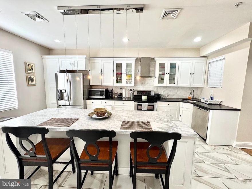 A very large newly rehabbed 4 bedroom, 3 full bathroom, a 1/2 bath house with 2 zones heating and cooling in a super convenient location. First floor- open floor w/ hardwood floors throughout, large open front window. Custom stairs going to 2nd floor. 1/2 bath with custom tiles with large window. Dining room area that opens up to a large Chef's Kitchen. Electric stove top with two ovens, stainless steel appliances, wine built in microwave and wine cooler in the large island. Granite countertops, custom tile back splash with white cabinets. Sliders to a huge yard. Small finished basement for storage with washer, dryer electric hot water tank electric heat. 2nd floor rear bedroom with its own bathroom w/ large window Bathroom with custom tiles, granite countertop, seamless glass doors to stand up shower, Large hall bath w double bowl sinks, Jacuzzi tub, custom tiling. Front bedroom w large front window hardwood floors large walk-in closet Third floor rear bedroom closets w/ large front windows - lots of natural light. Hall wall closet with 2nd HVAC system. Front bedroom large window w/ large walk-in closet it, a full bathroom custom tiling w a large walk in shower w 4 shower heads. Big but comfortable house!