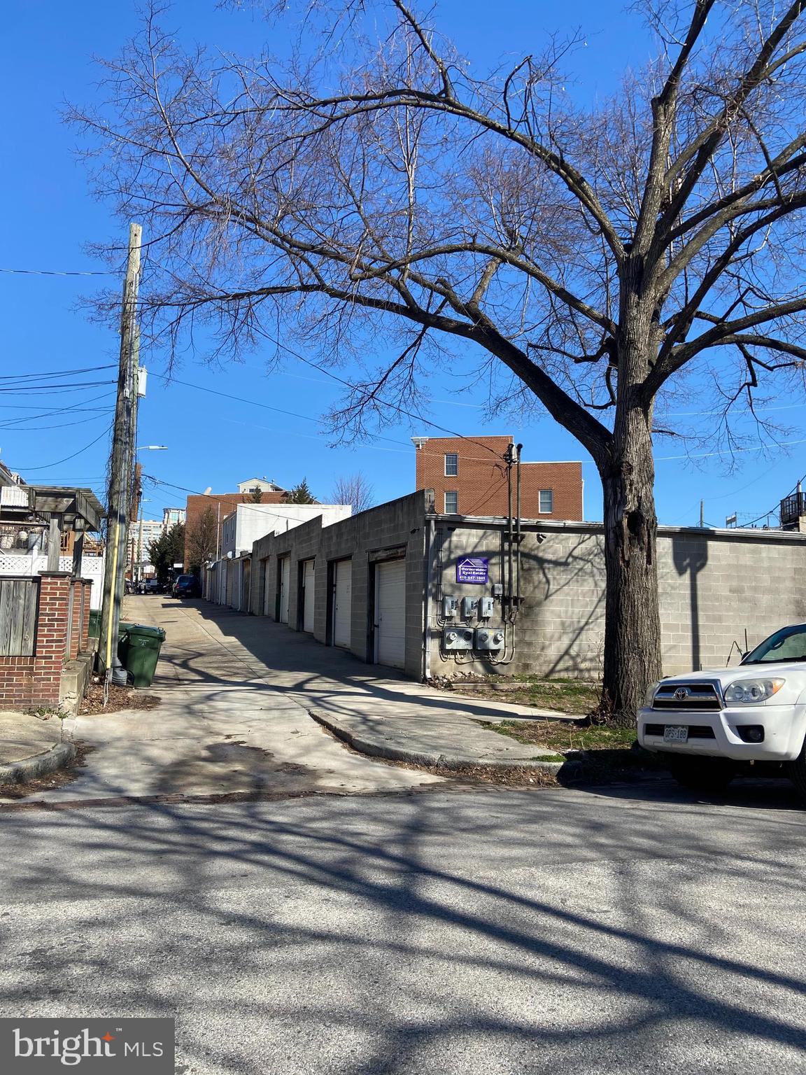 Very rare .20 acre parcel of land used for storage garages and five parking spots, located directly next to Southside Shopping Center. The structure features a personal door and two drive-in doors. There is a chain link fence that secures four storage garages as well as a service garage. The building has a gross building area of approximately 2,780 square foot, and total square footage of 8,767. All public utilities are available on site, which includes natural gas, electric, and telephone and is provided by public utility companies. Plot map and rent roll is included in the listing. Possible site for new houses.