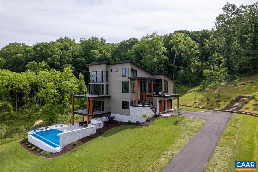 *Seller/Creative Financing Available* Experience unparalleled living in this breathtaking Lexington, Virginia estate, perched atop a ridge with panoramic views of the Blue Ridge Mountains and the city of Lexington. This 4,980 sq. ft., 4-bedroom, 4.5-bath home exudes luxury with custom design features, including a grand 9-foot pivot door, floating staircase, 7-inch oak hardwood floors, and cedar ceilings.  The gourmet kitchen boasts GE Caf� appliances, quartzite countertops, and a coffee bar. The primary suite features a balcony with stunning views, complemented by three additional spacious bedrooms and four and a half luxurious bathrooms. Each floor offers entertaining spaces and expansive decks.  The home includes a gym, sauna, loft area for stargazing, and an outdoor kitchen with a pizza oven, fire pit, and 10-person hot tub. The saltwater infinity pool with a swim-up bar enhances outdoor relaxation.  Enjoy maintenance-free living with custom cladding, Trex decking, and pre-wiring for a Generac generator. Don?t miss this rare opportunity to own a piece of paradise in Lexington, VA.