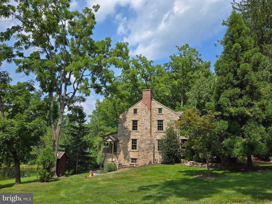 Your own private paradise awaits with this spectacular 104.4 acre private estate dating back to 1752 located in the heart of the Oley Hills Land Preserve.  On the market for the first time since 1945, this secluded country property was lovingly updated and restored to preserve its historical charm yet provide all modern conveniences.  This gorgeous 3-Story stone home includes four bedrooms, three and a half baths with an in-law suite, wine cellar that includes electric and storage for up to 120+ bottles, and the home has its original American Chestnut wood floors and original wood trim, as well as two walk-in fireplaces, a kitchen bake-oven, open beam ceilings and 4,242 square feet of living space.  The front covered 35’ x 8’ porch greets you and overlooks the ponds and has lighting and electric.  Step into the large foyer which has access to the powder room and leads you into the heart of this amazing home.  The formal living room (currently being used as the dining room), has a large fireplace with Bucks County Mercer Tile, open beamed, wood ceiling and chair-rail.  The formal dining room is quite spacious and has chair-rail and lovely views.  The large sunroom has a vaulted ceiling with skylights and ceiling fans, wood ceilings, beautiful American Chestnut radiant heated flooring, built-in bookcase, 8’ Pella sliders opening to the rear brick patio, as well as access to the primary bedroom suite, wine cellar and kitchen. 
 Cooking will be a delight in this updated kitchen with soapstone counters, Meile appliances, including an induction cooktop with downdraft, wall convection oven, speed oven and warming drawer, walk-in fireplace, copper sinks, solid Maple custom cabinets, wood beam ceiling and radiant flooring.  Upstairs, you will find a large foyer/sitting room and a separate laundry area with wood beam ceiling, two spacious bedrooms with large closets and wood beam ceiling, a lovely, updated hall bath with a tub/shower combo and the primary main suite, which includes the original wood floors, walls and ceiling, attic access and a private staircase to the lower level.  The primary bath has a large glass shower stall, an antique clawfoot tub, radiant floor heating, beam ceiling and a double vanity.  The lower level of this unique home holds the in-law quarters, which has a private entry, pond view and has a living/bedroom with a walk-in fireplace with wood stove, wood floors with radiant heating, a kitchen/dining area with all appliances, radiant heated wood floors and pantry as well as a full bath with radiant heated flooring and shower.  There is also a mechanical room.  There are 13 outbuildings which include a 45’ x 85’ 1830s bank barn with space for up to 12 horses (allowable horses is 1 per acre), a late two-story 1700’s wagon shed, a two-story three car garage, multiple run-in sheds for horses or livestock, and a 50 ’x 100’ building for an indoor riding ring, tennis court, or storage.  Approximately 25 acres of rolling pastures with miles of fencing and private walking/riding trails, 40 acres of woodlands with mature timber for harvest, plus 40 acres of open tillable land with spectacular views of the Oley Hills.  There are 2 spring fed ponds and the property is bordered by township maintained roads on three sides.  The land is preserved under a conservation easement and is enrolled in the Clean & Green program.  This once in a lifetime opportunity offers endless possibilities.