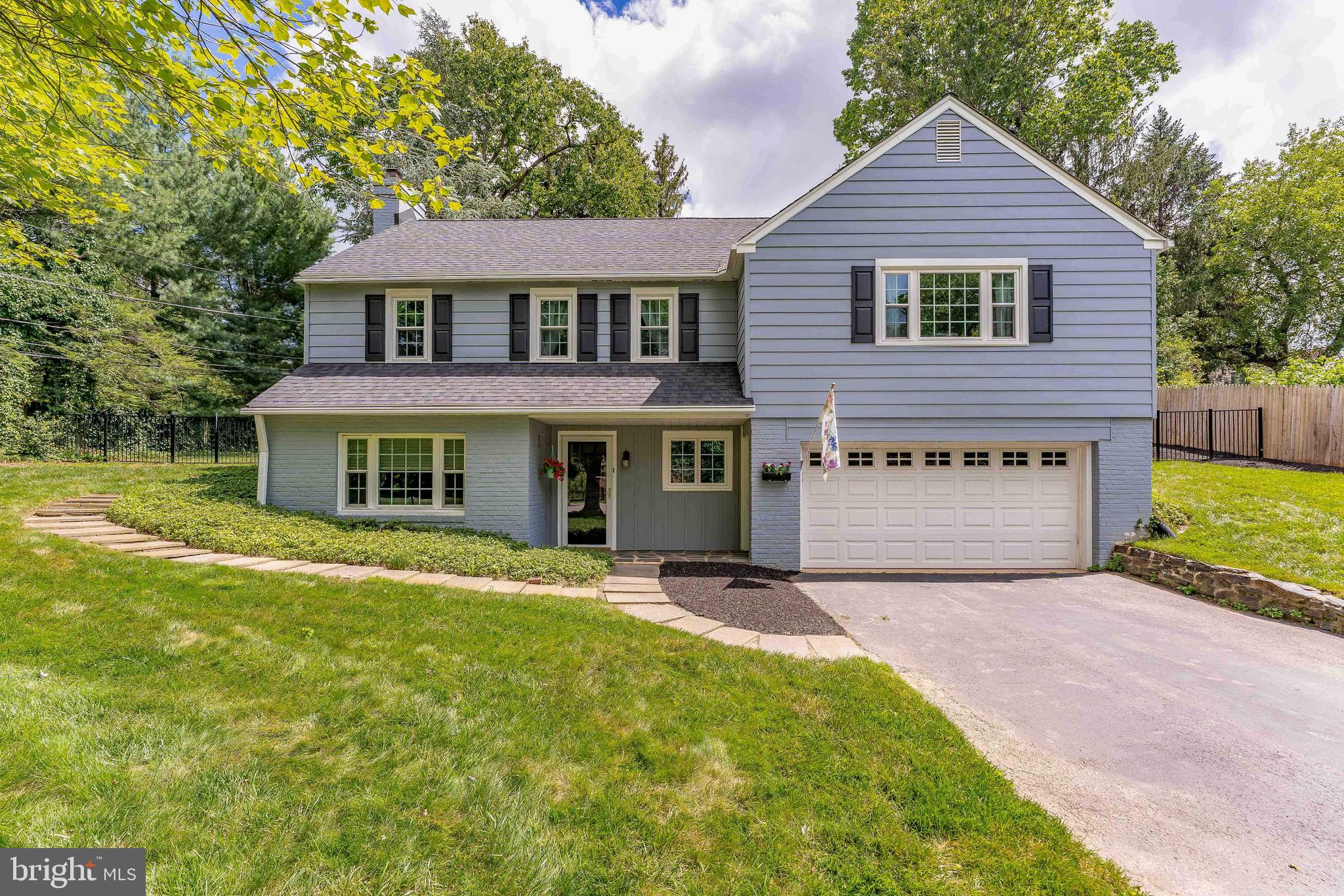 Welcome to 117 Locust Lane – a charming 3-bedroom, 1.5-bath raised ranch located in the highly desirable Media area, and in the highly acclaimed Wallingford-Swarthmore School District. Located on a quiet cul-de-sac, this home offers direct walking access from the cul-de-sac to expansive green space featuring a playground, a brand-new soccer field, and open areas where locals often gather for casual games of pickleball. The area is also dog-friendly, making it perfect for the whole family — pets included. This one-of-a-kind home is rich in history and character, featuring bricks salvaged from the historic Chinese Wall near 15th and Market Street in Philadelphia, which was demolished in 1958. Step inside to a welcoming foyer with slate flooring. From there, enter the spacious family room, where rustic slate floors, exposed wooden-beamed ceilings—crafted from timber sourced from an 18th-century log house in Honeybrook—and a cozy wood-burning fireplace creates a warm, inviting atmosphere. Just off the family room, you’ll find the laundry and utility area, complete with carpeted flooring, built-in cabinetry, a laundry tub, and all the home's mechanical systems. Adding even more local charm, the downstairs hallway floor includes bricks repurposed from an old sidewalk in Media. A powder room with laminate flooring and overhead lighting is conveniently located nearby. Upstairs, the main level offers a bright and airy living room featuring hardwood floors and elegant crown molding. The living space flows seamlessly into the dining room, which also boasts hardwood floors, crown molding, built-in cabinetry, and a charming Dutch door leading to the rear patio. The kitchen offers an electric cooktop and picturesque views of the backyard through classic casement windows. Nearby, a recently updated full bathroom includes ceramic tile, a marble sink, and a tub/shower combo with sliding doors. The primary bedroom features hardwood floors and two closets. Two additional bedrooms—also with hardwood floors—offer versatile space for children, guests, or a home office. Pull down stairs allow access to a full length attic that is floored for storage or potential to add more living space. Beyond its distinctive architectural details, this home is ideally located close to local shopping, grocery stores, restaurants, and beautiful Gouley Park. Easy access to I-476 ensures a smooth commute to wherever you need to go. Don’t miss your chance to own a truly unique home in a prime location—schedule your tour today!