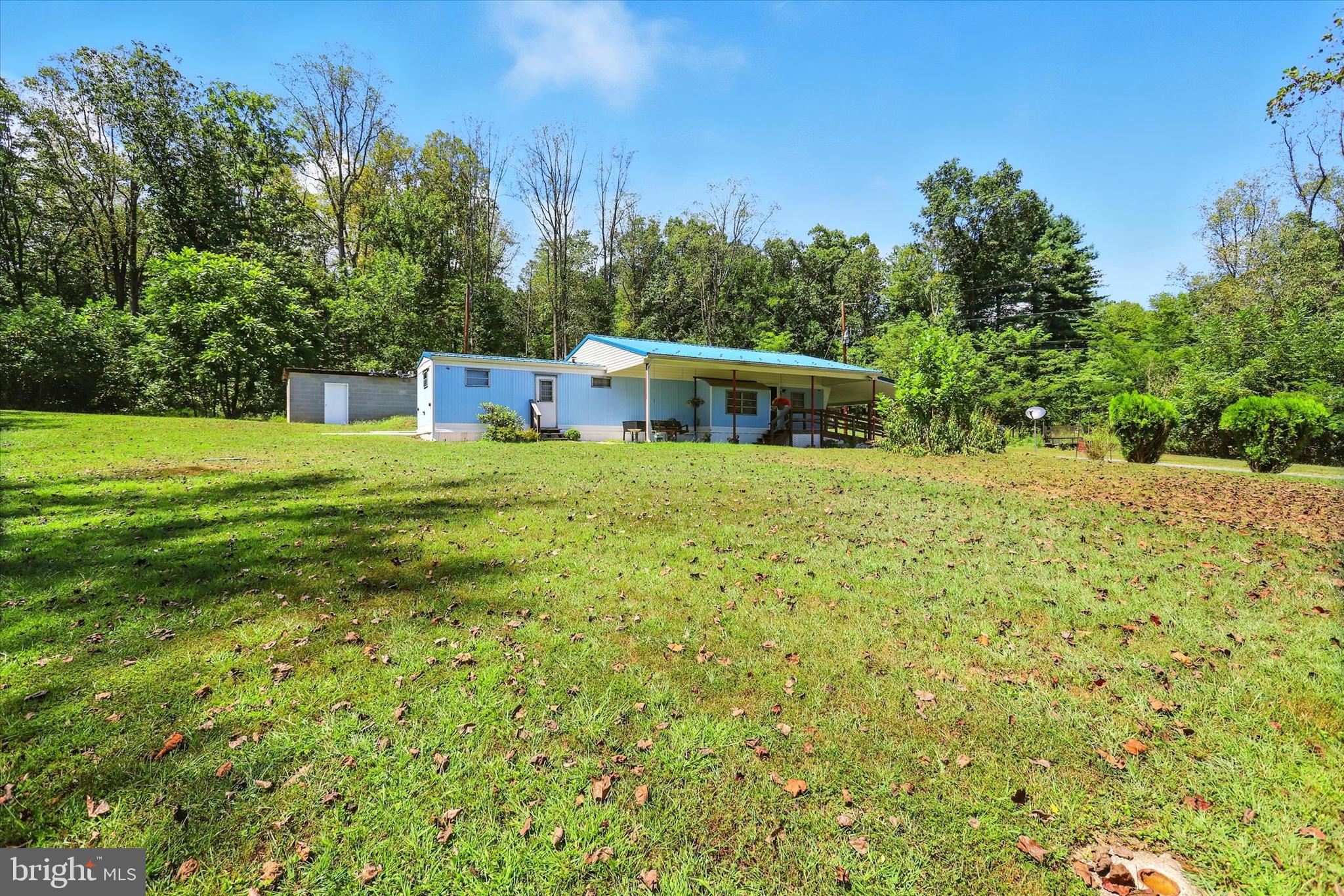 Discover the charm of country living at 561 Path Valley Road, Fort Loudon, PA—a 1962 Pacemaker mobile home nestled on approximately 2.2 acres. This 4-bedroom, 1-bath home offers a cozy and functional layout, featuring a kitchen-living combo, forced-air heating, and window unit cooling. Constructed with durable aluminum and steel siding, the home sits well off the main road, providing privacy. Although the bedrooms are smaller, the addition features a large bedroom and extra family room! The home has been well taken care of and has had the winterization program completed by the county for many updates inside and out. This property would make for the perfect rental or a temporary place to call home while building your new home. You can’t replace the lot, with its spacious layout and awesome mountain views! There is also a concrete building that used to be a smokehouse and a second 2-story block building on site. Cash preferred but financing may be available with 15-30% down at Community State Bank or Bank of Landisburg.