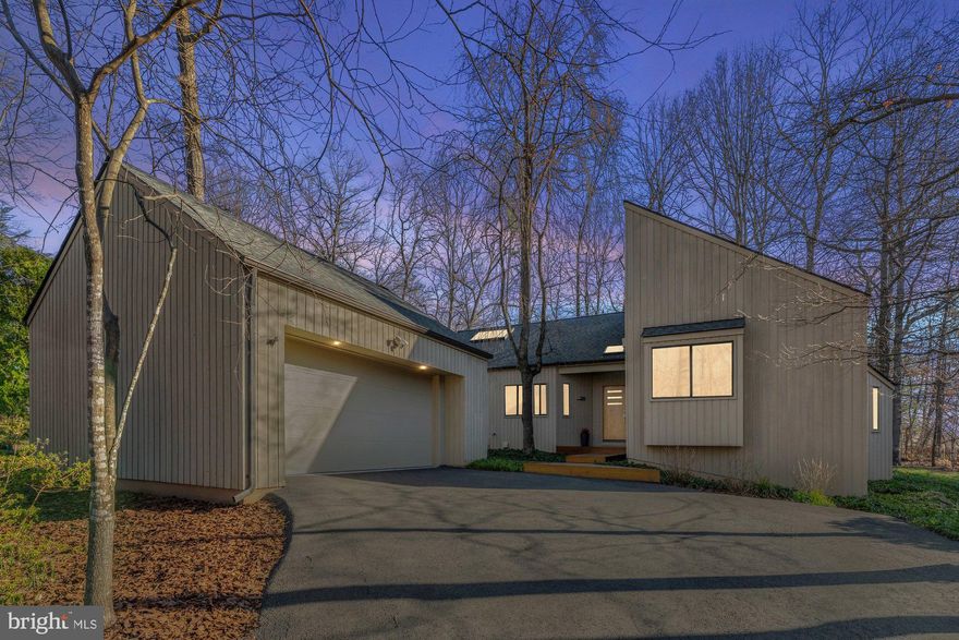 Impeccable mid century modern home with top-to-bottom renovation in the highly desirable Reston community with a water view. This home features 3 bedrooms, 2 bathrooms, 2,149 square feet and is sited on 0.28 acres. Unique floor plan presents an appealing blend of open spaces and cozy living areas. Smart home technology provides the ability to control lighting, garage doors, and thermostats. Large windows and high ceilings ensure a bright and inviting atmosphere throughout, while sleek, durable hardwood flooring unifies the space. Open concept living area that seamlessly connects the living room and dining room, perfect for gatherings and creating lasting memories. Gourmet kitchen equipped with elegant granite countertops, stainless steel appliances, center island with electric cooktop, double wall ovens, and ample cabinetry. Breakfast room with high ceiling and skylight, has easy access to the heated screened-in porch. Main level owner's suite has a dressing area with tons of closet space and spa-like en suite bathroom that features a custom tiled walk-in shower, heated tiled floors, and double sinks. This level also features two generously sized bedrooms, one with a built-in loft bed, full bathroom, and laundry room. Step into your outdoor haven, with a spacious deck perfect for grilling or hosting festive gatherings. The hot tub transforms this home into a personal oasis. The ideal fenced-in backyard includes a county buffer between lots, providing a peaceful escape from the hustle and bustle of city life, with a wooded lot. 2 car detached garage with built-in storage and plenty of parking space on the driveway. Conveniently close to private cluster dock at Lake Audubon and provides easy access to the water, allowing you to launch paddle board or kayak without delay. The location and neighborhood is close to all the amenities, shops, and restaurants you need. Nearby Terraset, Hughes, and South Lakes Pyramid.