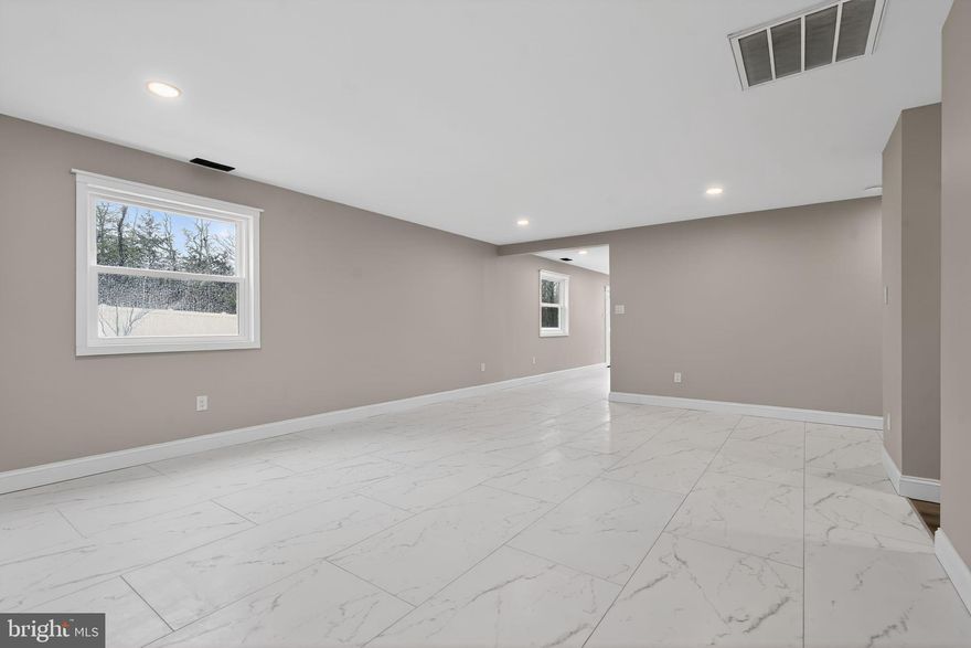 This charming ranch-style home underwent a  major renovation in 2025 and now offers a perfect blend of comfort and modern living. The renovation included: New Windows, New Roof, New Siding, New Hot Water Heater and so much more! With 1,504 sq. ft. of thoughtfully designed space, this home features three inviting bedrooms and one and a half bathrooms, ideal for both relaxation and entertaining. Step inside to discover an open floor plan that seamlessly connects the kitchen and dining areas, enhanced by recessed lighting and a cozy wood-burning fireplace, perfect for those chilly evenings. The kitchen boasts stainless steel appliances, including a built-in microwave and gas range, along with an island that invites culinary creativity with beautiful quartz countertops.  The main floor laundry adds convenience to your daily routine. Luxury vinyl plank and tile flooring throughout, ensuring both style and durability. Energy-efficient double-pane windows contribute to a comfortable atmosphere year-round. Outside, the expansive 0.43-acre lot features beautifully landscaped front and rear yards, perfect for outdoor gatherings or quiet moments in nature. The extensive hardscape and outdoor kitchen create an inviting space for entertaining, fully fenced with brand new vinyl fencing, while the attached garage and ample driveway parking provide practicality. This home is not just a place to live; it's a sanctuary where memories are made. Embrace the opportunity to make it your own!