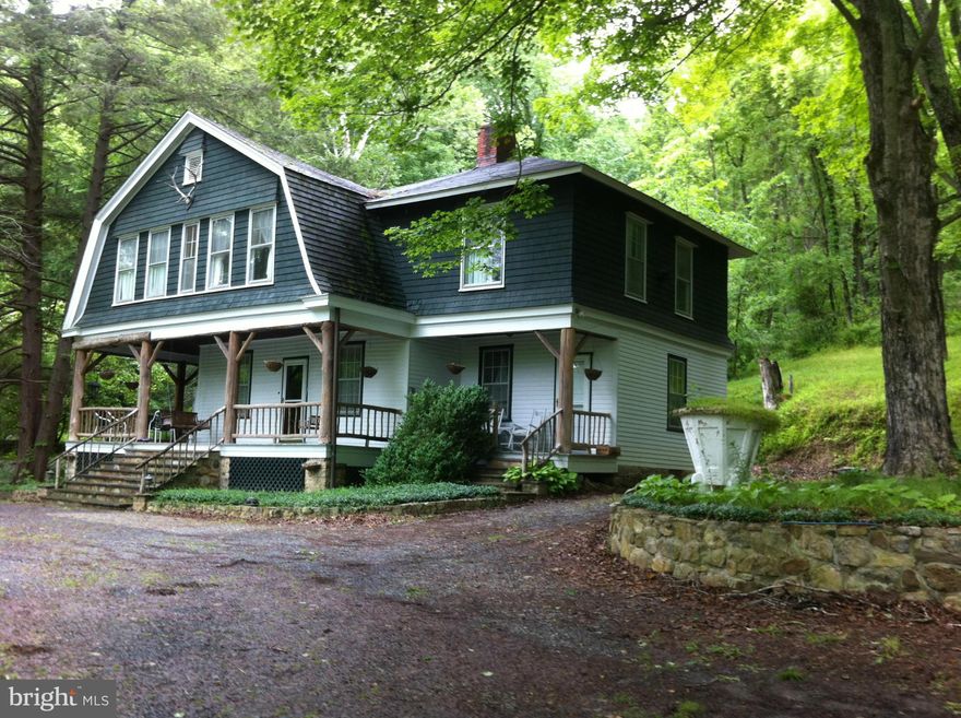 GREAT DEAL! 4 parcels total 32 acres straddling the Cacapon River w/ a large 1900 2 story home w/ all modern amenities. Wood + slate floors, moldings, 2 stone FP , cedar log walls, wood ceiling, great porch and more. Spring fed stream with small fish pond along the side of home creates enchanted garden. Big pond between road and river, huge trees. Aviary + cottage. Kayak  canoe fish. DELIGHTFUL!