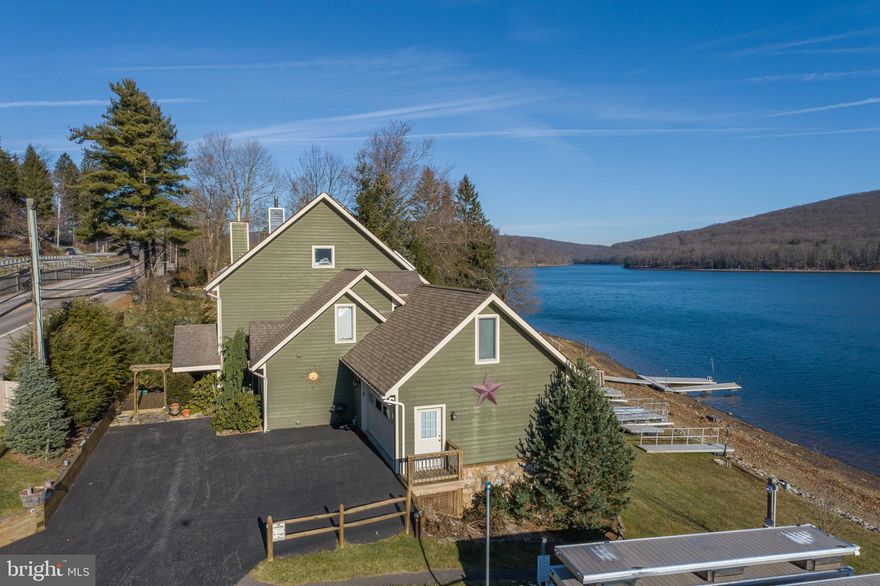 Indulge in the beauty of stunning views and a tranquil waterfront setting with this spacious 5-bedroom, 4.5-bath retreat. Boasting three master suites, each offering comfort and privacy, this home is designed for a luxurious lakeside lifestyle.

Enjoy the convenience of a private Type "A" Dock system, providing easy access to Deep Creek Lake. The lakefront sunroom is a haven for relaxation, offering panoramic views of Deep Creek Lake and the serene Deep Creek Lake State Park.

Store your lake toys with ease in the attached three-level garage, providing ample space for all your recreational gear. Central heating and air conditioning ensure year-round comfort, allowing you to appreciate every season at its best.

This home comes mostly furnished, offering a move-in-ready haven where every detail has been considered. Experience ultimate lakeside living with this exceptional property. Call today for your showing appointment