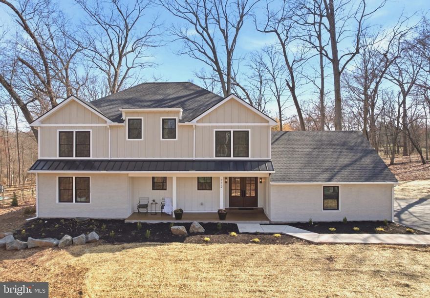 Move-In Ready Luxury with the Feel of New Construction—Without the Wait! Privately tucked at the end of a quiet cul-de-sac-style lane in the Hidden Forest setting of Skippack Township, this home sits on a rare 1.68-acre flat, park-like lot—offering an extraordinary blend of privacy, space, and refined living.

UPGRADES & ADDITIONS: Extensively upgraded, expanded, and reimagined for modern living, this home showcases exceptional craftsmanship and thoughtful design throughout. Major improvements include a second-floor addition, a fully rebuilt and redesigned main level, and a finished walk-out basement offering added versatility and living space. The home features all-new systems, including dual high-efficiency Carrier HVAC units, new double-hung windows, single-panel interior doors, a new roof, custom trim work, premium JAMES HARDIE, and SOLID HARDWOOD flooring throughout for lasting durability and elevated style. Enjoy the newly built front and back porches, complete with Metal roofs, tongue-and-groove ceilings, and recessed lighting. Additional upgrades include all-new electrical and plumbing brought up to current code, West Elm vanities, and custom carpentry throughout.

INTERIOR . A grand double-door foyer opens to thoughtfully designed living areas, including both a formal living room and a spacious family room featuring custom RH-inspired built-ins and a wood-burning fireplace. The main level has been carefully designed to offer the best of OPEN-CONCEPT living while still creating a sense of separation and privacy. Smartly integrated storage solutions—including a custom walk-in closet—provide flexible space to keep everyday living organized.

The GOURMET kitchen is a true showpiece, centered around a dramatic waterfall-edge quartz island and outfitted with premium cabinetry, pantry storage, stainless steel appliances, and a 6-burner GAS range.  A seamless quartz backsplash and custom hood create a timeless, high-end look, while the commercial-grade exterior-vented exhaust delivers top-tier performance. Built-in microwave and wine/baverage cooler, garage disposal. 

The MAIN level also features a private BEDROOM suite complete with a full bathroom and walk-in closet—ideal for office, guests, extended family, or multigenerational living—along with an ADDITIONAL well-appointed powder room for everyday convenience. A dedicated LAUNDRY room enhances functionality with built-in shelving, cabinetry, and a utility sink.

UPSTAIRS:  primary suite—enhanced by the addition—offers a true retreat with soaring cathedral ceilings, a sunlit sitting area, peaceful wooded views, and a spa-inspired bath featuring slate flooring, a quartz double vanity, and a luxurious multi-head walk-in shower. Three additional bedrooms showcase solid hardwood flooring, recessed lighting, ceiling fans, and generously sized custom built-in closets. A beautifully appointed hall bath impresses with a double vanity, designer tilework, and elegant architectural arches. The second level is further elevated by a stunning hallway, custom-designed IRON RAILING and balusters, and a grand two-story foyer staircase that adds timeless sophistication. Thoughtfully designed for comfort and efficiency, this floor includes its own HVAC system installed in the attic, convenient hallway attic access, and large windows in every room that fill the home with natural light while capturing serene views.

The partially finished BASEMENT adds valuable flexibility, with both interior access and walk-out exterior steps. Ideal for a playroom, home gym, media room, or mancave, the space also includes built-in shelving for practical storage.

Ideally located just minutes from Skippack Village, this home offers easy access to boutique shopping, dining, and year-round community events. With convenient access to the Pennsylvania Turnpike, commuting to King of Prussia, Philadelphia, and beyond is effortless—all within the highly desirable Perkiomen Valley School District.