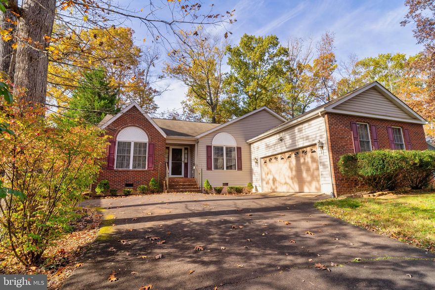 Fantastic  location with views on the #15 Fairway of the Golf Course, plus a view of Keaton's Lake across the street! Very popular split bedroom floor plan with awesome sunroom/sitting room in the owners suite offering golf course views! Open, spacious, one level, flowing floor plan with cathedral ceilings, skylights, gas fireplace, pocket doors, lots of ceiling fans & more!  Large kitchen with breakfast counter bar, eating space with a true bay window & handy built in desk area.  Owners suite has large walk-in closet, luxury whirlpool bathtub, separate shower & double vanity. The sitting room or sunroom can be an office, nursery, or flex room.  Bedroom 2 & 3 with own bathroom & a pocket door to close off this wing from the living area. There is a whole house generator in case of power outage, heat pump updated in 2009, nice brick step entry, brick front accents and a paved driveway! Large 24' x 12' rear deck & a side load 2 car garage. Move right in or bring your decorating ideas,  sparkly clean but could use updating, priced accordingly! Close to the small lake, beach & 18 hole PGA Golf Course. The "Woods Center" for carry out or eat in after a round of golf, plus Clubhouse dinners, sports lounge & Sunday brunch.  Amenity rich community, has 2 lakes for boating & swimming, 2 pools, community centers, parks, ball fields, beaches, marinas,  tennis, pickleball, fitness & equestrian centers, concerts, a variety of clubs,  events & much more!