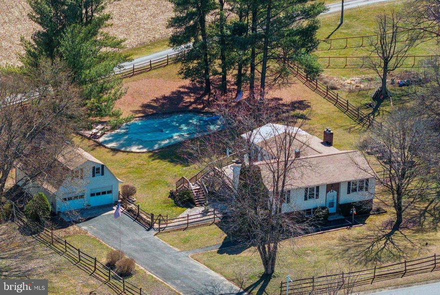 Welcome to this charming 4-bedroom, 2.5-bathroom split-foyer home nestled on nearly an acre of peaceful land, featuring an in-ground pool and an oversized detached garage! Upstairs, you'll find 3 generously sized bedrooms, while the lower level offers flexible living space with a rec room, a bar, a cozy wood-burning fireplace, a full bathroom, a bedroom, and a den, perfect for guests or a home office. The updated kitchen features stainless steel appliances, a double oven, and ample cabinet space, making meal prep a breeze. Adjacent to the kitchen, the spacious family room with vaulted ceilings provides a welcoming space to relax or entertain. Enjoy your morning coffee on the deck or in the sunroom, both offering beautiful views of the backyard, pool, and the scenic pastures beyond.

The oversized detached 2-car garage is equipped with electric service and attic space, ideal for storage or converting into a potential office or rec room. In-ground pool was resurfaced, and new systems were updated in 2021. This home has been thoughtfully updated with a brand-new roof on the house and garage, refinished hardwood floors, updated bathrooms, new HVAC system, and new windows. With its blend of modern upgrades and tranquil setting, this home is ready to impress. Don’t miss your chance to make it yours!