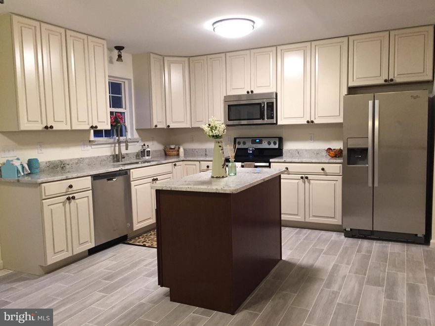 Beautiful Renovated 4 bedroom 2 bath home ready for you to move in. Home features new custom cabinets, granite counter tops & stainless steel appliances. French doors leading to spacious deck perfect for entertaining and large fenced yard. New tile floor in kitchen and bathrooms. Finished basement with rec room & large bedroom. Come see it today!