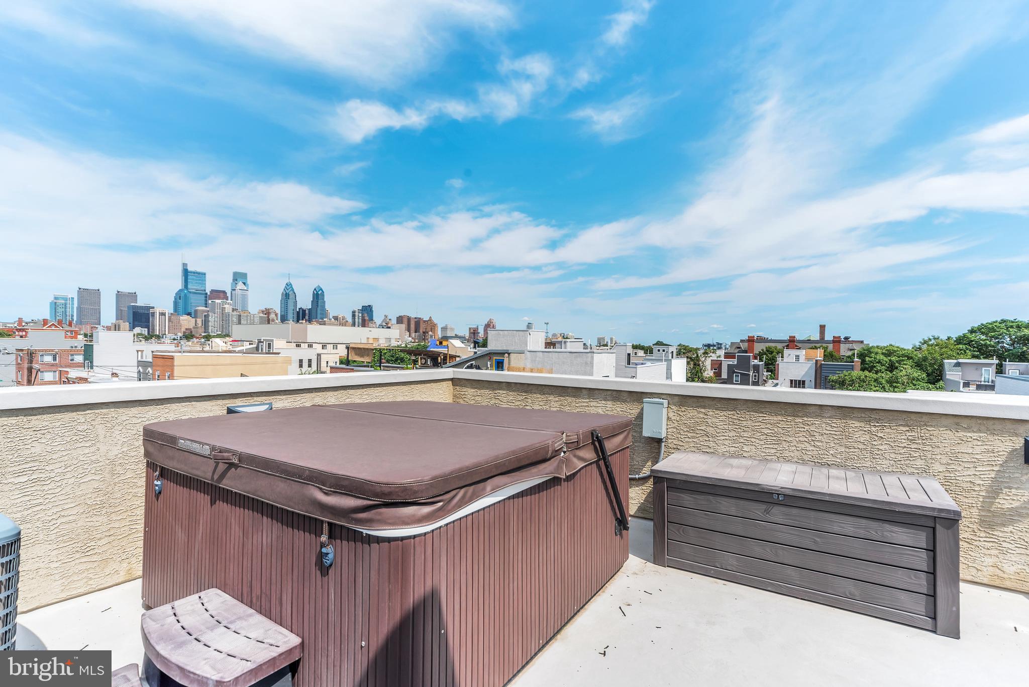 Welcome to 2403 Manton Street! Parking, hot tub on the roof top and a theater! Don’t miss this stunning luxury rental property in Point Breeze, just 2 blocks from Graduate Hospital with incredible finishes and amenities throughout, including an attached 1-car garage! Upon entering, step into the living area with dramatic high ceilings, oversized windows and gorgeous hardwood floors. On the second level, you’ll find the luxury kitchen features an island with a waterfall edge, stainless steal appliances, a wine fridge, ample storage and room for a dining table. The finished basement offers an at-home theater with a large mounted TV, dark walls, and two rows of recliner seats perfect for hosting movie night. The third floor features two large bedrooms, both with ample closet space, and a spacious hall bathroom. The laundry space is also located on this level. Walk up to the fourth level to find the primary suite with a large bedroom, a wet bar spanning the entire hallway, a walk in closet, and a huge bathroom that offers a glass rain shower, soaking tub and double vanity. Continue up the stairs to find the amazing roof deck with 360-degree views of the city, a hot tub, and grill. With electric and water access, this rooftop is perfect for hosting! In close proximity to all of the restaurants, bars, grocery stores, parks, and coffee shops that Point Breeze has to offer, this home is in a perfect location. Schedule your showing today!