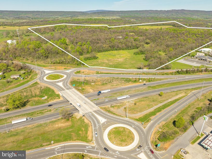 205± acres in a prime location along Interstate 81 in Inwood, West Virginia. Situated in Berkeley County, WV and just 5 miles from Frederick County, VA—two of the region’s fastest-growing areas. With no zoning restrictions, this property offers limitless potential for residential, commercial, or industrial development. Recent infrastructure improvements include an I-81 traffic circle and newly elevated exit ramps, enhancing accessibility and traffic flow. The land features relatively flat, open fields with excellent visibility and gently rolling slopes, making it an ideal site for a dynamic mixed-use development, whether for commercial, residential, or industrial purposes