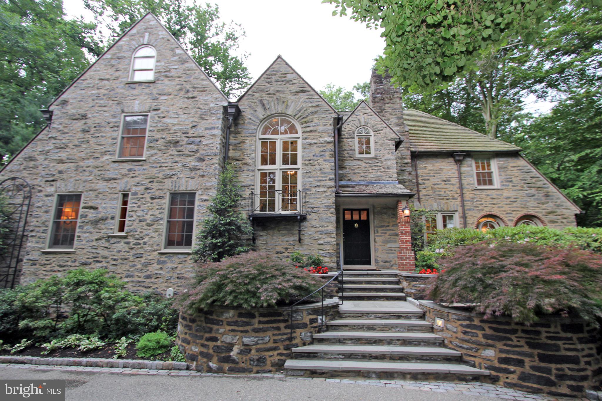 This is it! The quintessential Main Line stone manor home located in Northside Haverford! 334 Laurel Lane is a luxury property featuring 6 beds 4 full and 2 half baths and nearly 6,000 sq. ft. of interior living space. Outside, admire the circular driveway, stone pathways and walls. Beyond the classic flagstone patios find a secluded oasis. The back yard entails your own natural grotto with waterfall and pond. Inside, this home has been completely renovated with beautiful millwork, hardwood floors, a sun drenched kitchen with skylights, top of the line appliances, timeless white cabinetry and includes a butler pantry and rear stairs. The dining room offers french doors to rear yard with stunning year-round views. The great room offers a marble fireplace and beyond a sunroom used all year round. There is a first floor office/den with fireplace and custom wood moldings, built-ins and wainscoting that exude quality and style. Two powder rooms and an indoor potting/garden room complete this level. Upstairs, find an incredible Master Suite with his/her separate closets, a newly renovated Master bath with separate tub & shower - double vanity and more! The master suite offers three walls of windows (all recently replaced), recessed lighting and more. On this level, you will find another en-suite bedroom and a jack n jill bedrooms with bath shared in-between. All 3 bathrooms on this level are newly renovated. Down the hall find a laundry room and rear staircase. Go up to the finished 3rd floor and enjoy two more bedrooms and a full bath with walk-in attic storage. The lower level is where you have an attached 3 car garage, an exercise room and plenty of storage. Move right in to this stately classic home featuring every possible modern day convenience. Perfectly situated near the Merion cricket club, Suburban Square, train station, shops and more.
