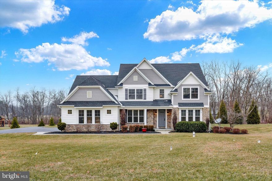 Welcome to 7186 Sterling Road, a stunning Carricato-built home in desirable West Hanover Township, perfectly situated between Harrisburg and Hummelstown. This impressive 2-story residence offers 4 bedrooms, 4.5 baths, and 3,928 sq. ft. above grade, blending luxury, craftsmanship, and thoughtful design throughout.
Step inside to a gracious dining room featuring hardwood floors, a coffered ceiling, and elegant wainscoting. The soaring vaulted family room showcases a beautiful fireplace, recessed lighting, and a mounted TV that remains. The kitchen is well-appointed with hardwood floors, a gas cooktop, pot filler, oversized pantry, and all Bosch appliances including the refrigerator remain. A tile-floored half bath, dedicated office with hardwood floors, and a spacious mud/laundry room with a wash sink, tile flooring, built-in bench, and coat hooks complete the main level.
Upstairs, the expansive primary suite features a vaulted ceiling, a luxurious bath with a free-standing tub and tiled shower, and a remarkable walk-in closet with wood built-ins. The second bedroom also offers a vaulted ceiling and its own private bath. Bedrooms three and four each include walk-in closets and share a full bath with a linen closet. Ceiling fans are found in all bedrooms. Additional highlights include gas heat with dual HVAC units and a water treatment system for the property’s well.
The fully finished basement provides exceptional added living space, complete with a full bath, granite bar with sink and wine fridge, vinyl plank flooring, fireplace, built-ins with a TV that remains, and a dedicated exercise room.
Set on a level 1.52-acre corner lot, the exterior features a 3-car side-entry garage, invisible fence, a welcoming covered front porch, and a relaxing covered rear patio—ideal for entertaining or quiet evenings outdoors.
This exceptional property offers space, style, and quality in a prime location. Don’t miss the opportunity to make it yours!