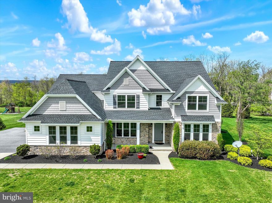 Welcome to 7186 Sterling Road, a stunning Carricato-built home in desirable West Hanover Township, perfectly situated between Harrisburg and Hummelstown. This impressive 2-story residence offers 4 bedrooms, 4.5 baths, and 3,928 sq. ft. above grade, blending luxury, craftsmanship, and thoughtful design throughout.
Step inside to a gracious dining room featuring hardwood floors, a coffered ceiling, and elegant wainscoting. The soaring vaulted family room showcases a beautiful fireplace, recessed lighting, and a mounted TV that remains. The kitchen is well-appointed with hardwood floors, a gas cooktop, pot filler, oversized pantry, and all Bosch appliances including the refrigerator remain. A tile-floored half bath, dedicated office with hardwood floors, and a spacious mud/laundry room with a wash sink, tile flooring, built-in bench, and coat hooks complete the main level.
Upstairs, the expansive primary suite features a vaulted ceiling, a luxurious bath with a free-standing tub and tiled shower, and a remarkable walk-in closet with wood built-ins. The second bedroom also offers a vaulted ceiling and its own private bath. Bedrooms three and four each include walk-in closets and share a full bath with a linen closet. Ceiling fans are found in all bedrooms. Additional highlights include gas heat with dual HVAC units and a water treatment system for the property’s well.
The fully finished basement provides exceptional added living space, complete with a full bath, granite bar with sink and wine fridge, vinyl plank flooring, fireplace, built-ins with a TV that remains, and a dedicated exercise room.
Set on a level 1.52-acre corner lot, the exterior features a 3-car side-entry garage, invisible fence, a welcoming covered front porch, and a relaxing covered rear patio—ideal for entertaining or quiet evenings outdoors.
This exceptional property offers space, style, and quality in a prime location. Don’t miss the opportunity to make it yours!