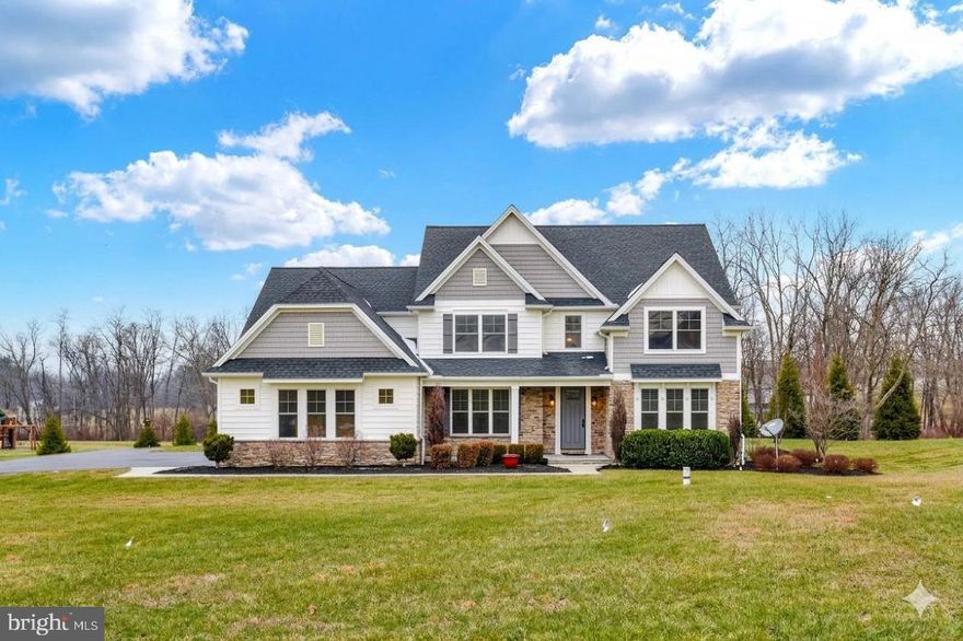 Welcome to 7186 Sterling Road, a stunning Carricato-built home in desirable West Hanover Township, perfectly situated between Harrisburg and Hummelstown. This impressive 2-story residence offers 4 bedrooms, 4.5 baths, and 3,928 sq. ft. above grade, blending luxury, craftsmanship, and thoughtful design throughout.
Step inside to a gracious dining room featuring hardwood floors, a coffered ceiling, and elegant wainscoting. The soaring vaulted family room showcases a beautiful fireplace, recessed lighting, and a mounted TV that remains. The kitchen is well-appointed with hardwood floors, a gas cooktop, pot filler, oversized pantry, and all Bosch appliances including the refrigerator remain. A tile-floored half bath, dedicated office with hardwood floors, and a spacious mud/laundry room with a wash sink, tile flooring, built-in bench, and coat hooks complete the main level.
Upstairs, the expansive primary suite features a vaulted ceiling, a luxurious bath with a free-standing tub and tiled shower, and a remarkable walk-in closet with wood built-ins. The second bedroom also offers a vaulted ceiling and its own private bath. Bedrooms three and four each include walk-in closets and share a full bath with a linen closet. Ceiling fans are found in all bedrooms. Additional highlights include gas heat with dual HVAC units and a water treatment system for the property’s well.
The fully finished basement provides exceptional added living space, complete with a full bath, granite bar with sink and wine fridge, vinyl plank flooring, fireplace, built-ins with a TV that remains, and a dedicated exercise room.
Set on a level 1.52-acre corner lot, the exterior features a 3-car side-entry garage, invisible fence, a welcoming covered front porch, and a relaxing covered rear patio—ideal for entertaining or quiet evenings outdoors.
This exceptional property offers space, style, and quality in a prime location. Don’t miss the opportunity to make it yours!