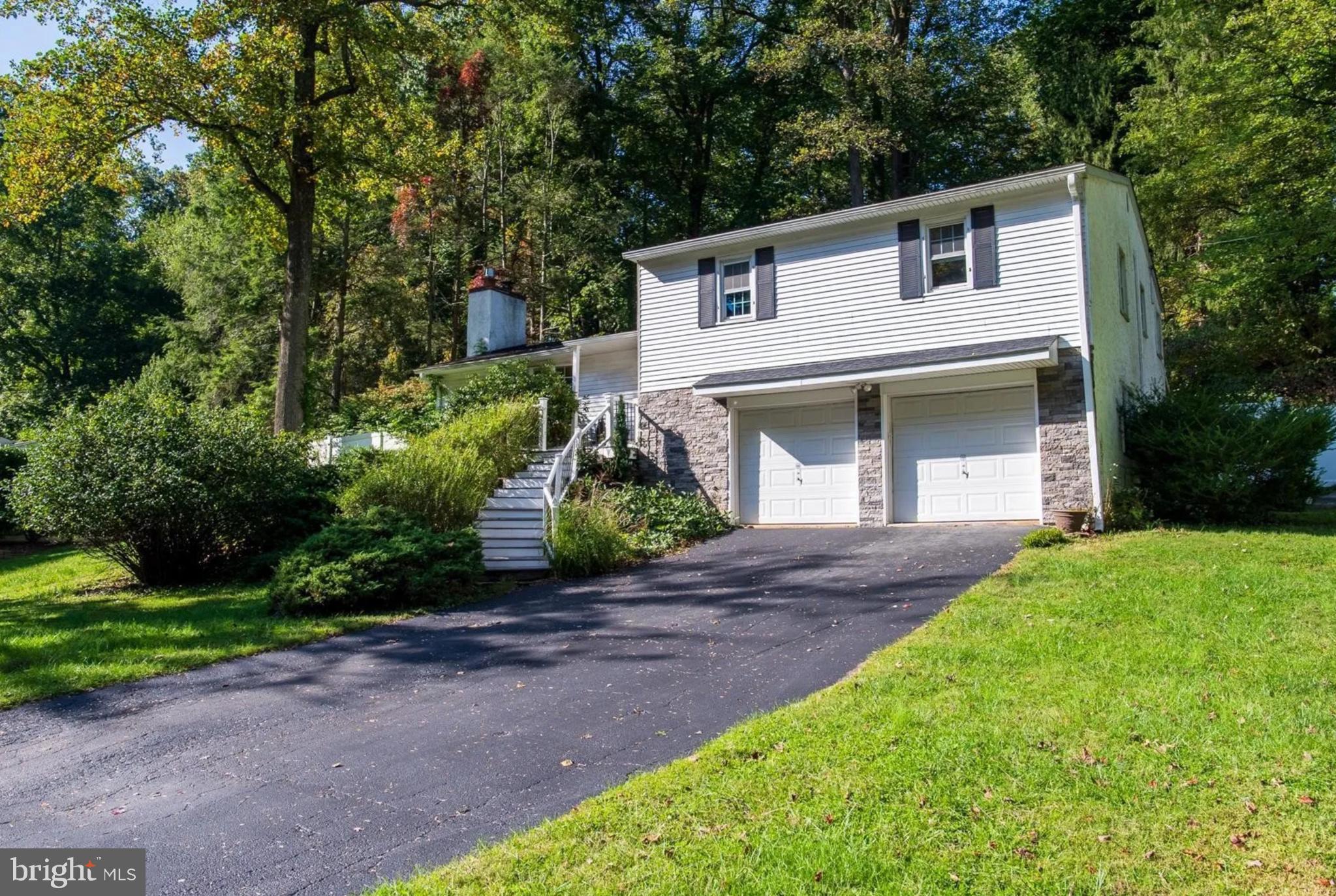 Gracefully situated on a quiet cul-de-sac, this elegant split-level residence offers a harmonious blend of comfort, style, and seclusion—just moments from the local high school. Bordered by a lush, wooded backdrop, the home provides a rare sense of privacy and natural beauty. Inside, a thoughtfully designed kitchen serves as the heart of the home, seamlessly flowing into sophisticated living and dining areas ideal for both everyday living and entertaining. The serene primary suite boasts a spa-inspired bath and a charming Juliet balcony, perfect for enjoying peaceful morning views. With three generously sized bedrooms and 2.5 well-appointed baths, the layout is both functional and inviting. An attached garage with direct basement access enhances convenience, while the two lower levels offer versatile space for hosting and leisure. Outside, a beautifully landscaped yard surrounds the in-ground pool, creating a private oasis for refined relaxation and effortless gatherings.