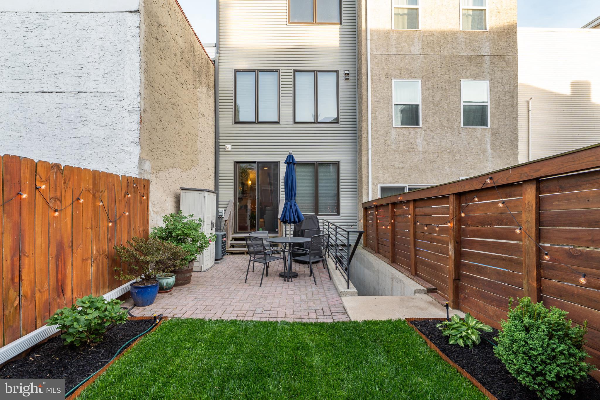 Introducing the meticulously cared for 2208 Trenton Ave. Custom built in 2015, 2208 is ideally situated on an impressive 16x96' lot and tucked away just off the main drag of the city’s most talked about neighborhood, Fishtown. Designed with both style and functionality in mind, this home offers a unique open floor plan that begins with a front-facing chef’s kitchen and a rare walk-out basement. The main level showcases rich natural red oak hardwood flooring and a dream kitchen featuring a center island, an abundance of 42" cabinets with crown molding, granite countertops, a ceramic tile backsplash, stainless steel appliances, under-cabinet lighting and a custom set of built-ins including a bench area at the entrance to hold all of the “daily stuff” — perfect (and important) details for everyday city living. The second floor offers two spacious bedrooms, including one with a large walk-in closet, a beautifully slate-tiled hall bath with a shower/tub combo, and a full laundry room with a side by side washer and dryer included. The entire third floor is dedicated to an incredible owner’s suite with a grand double-door entry, dual walk-in closets complete with built-in shelving, and a spa-like four-piece bath with an oversized stall shower and soaking tub. Continue up to find a full wet bar for added luxury and to access the private rooftop deck—over 500 square feet of outdoor entertainment space with spectacular city views. The roof deck has been outfitted with composite deck tiles + artificial grass, and a custom 12’ x 14’ covered pergola offering much desired rooftop shade. The fully finished walk-out basement boasts soaring 9-foot ceilings and includes a fourth bedroom, a full ceramic tile bathroom, a generous family room, and a separate storage room. Outside, the expansive fenced-in yard is a rare find in the city, complete with a brick-paved patio and a beautiful
landscaped additional green space, ideal for gardening and outdoor relaxation. All of this is just steps away from some of the best Fishtown has to offer - Riverwards Produce, Fiore, Yuhiro, Picnic, Philly Brewing, Mural City Winery, Zig Zag BBQ, Forin…the list goes on…an absolute 10 out of 10 for location. The residence is in close proximity to multiple playgrounds and is located in the Hackett catchment, just 2 blocks away. It's in the heart of it all, yet still tucked away on a double-wide cobblestone street, with bountiful (unzoned!) street parking. Don’t miss your chance to call this extraordinary property home. Available for an August occupancy. (Pet policy - inquire for details, no cats.)