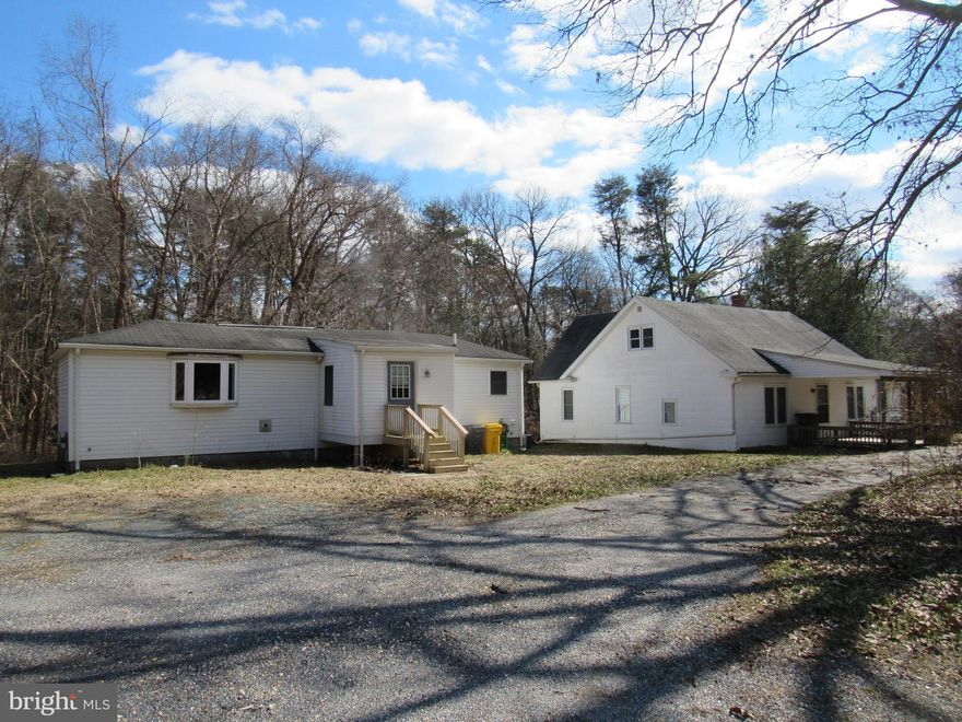 Buyer's cold feet put this back on the market. Four-plus acre compound!  Main structure features two bedrooms, one full bath, laundry room, and dedicated study/office area on the main floor.  Second floor includes two rooms used as bedrooms, plus closet space.  There is a second structure present that includes two bedrooms, one full bath, laundry room, and an office area all on one floor.  Property is accessed from a private road off of Ritchie Highway.  You won't believe that you are so close to restaurants and shopping, because it feels super secluded.  You really have to see this property to believe it!  Property is being sold as-is, is completely livable, but some TLC and updating will surely increase the value.