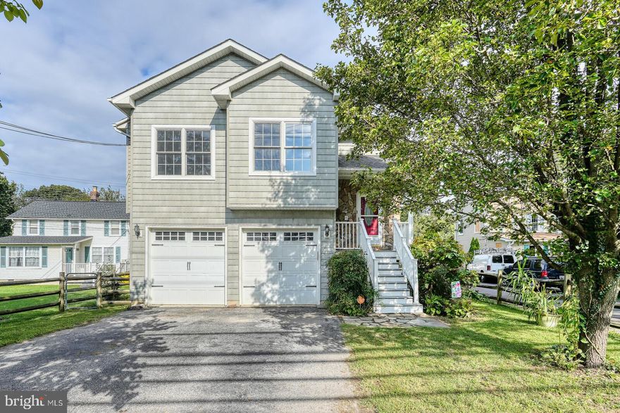 Welcome to this stunning home in the heart of Linthicum!  The owner's have done the hard work for you. The primary shower has been upgraded.  There are ceiling fans and recessed lights throughout.  The floorplan is so open and all the windows offer so much natural light.  The dual decking is awesome!  The rear yard is long and vast offering entertaining happiness, plus an irrigation system.  There are two sheds in the rear.  There is also an RV connect, 30 AMP and another 20 AMP outlet.  Oh wait, did I mention the hot tub?  You can relax and rest those weary bones  as you soak and enjoy the vast rear yard.  The two car garage has so much space, yes cars will fit!  The Lennox HVAC system is so much more than expected.  The LL has a woodstove, walkout to the rear and a full bath.  The upper level high ceilings open up the entire space.  The property is rear fenced and back to trees.  All of this privacy and still quick access to the airport, all routes and shopping.