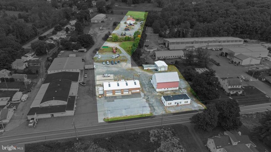 Great opportunity to own a prime industrial property with multiple buildings in a desirable location. Property is approximately 5.48 acres and consists of 6 total buildings.  Main garage is approx 52 x 82 and has 3 each 12 x 12 ft doors and 1 each 14 x 14 ft door; Office building is approx 55 x 24; Barn is approx 55 x 40; Block building is approx 28 x 42 and has 3 each 9 x 7 ft doors (lower level) and 2 each 10 x 10 ft doors (upper level); Frame building (attached to block building) is approx 38 x 22; Garage Pole Barn built in 2019 (rear of property) is approx 48 x 40 and has 4 each 12 x 14 ft doors.   Numerous possibilties exist for this property.