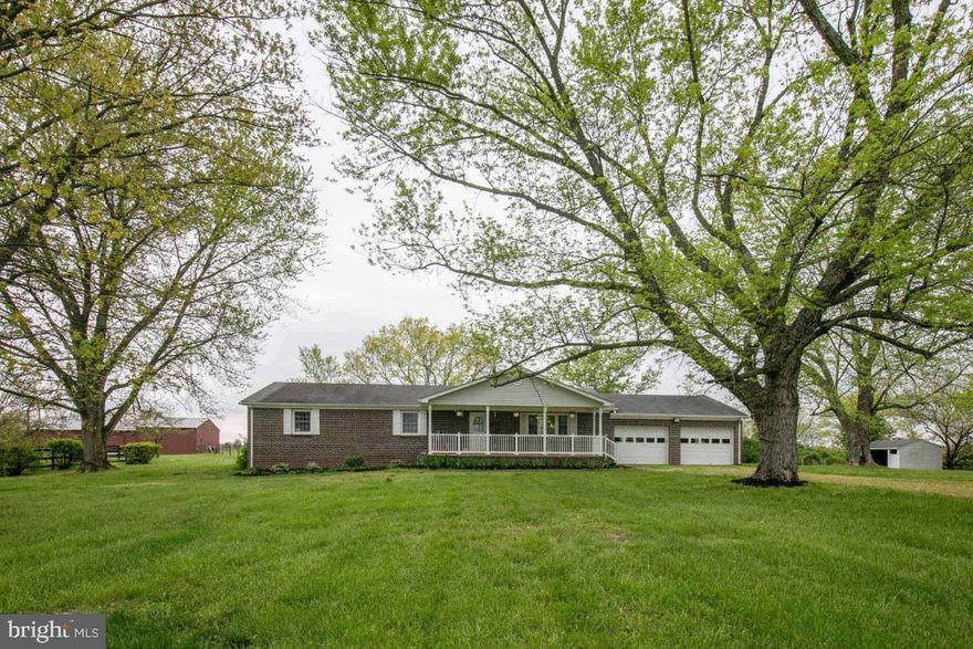 Welcome to your private country retreat—this beautiful 4-bedroom, 3-bath brick home sits on 12.49 acres and offers the perfect blend of comfort, functionality, and opportunity for homesteading or small-scale farming. This property is thoughtfully set back from the road via a long driveway easement, providing peace, privacy, and scenic surroundings.

The home features spacious bedrooms, including a secondary bedroom with its own private entrance—ideal for guests or flexible living arrangements. Enjoy hardwood floors, a cozy woodstove, and two heat sources (oil and electric) for year-round comfort. Additional highlights include a large mudroom, whole house fan, tankless water heater, water filtration system, and updated systems such as a newer roof (2022), electrical panel (2023), and modern appliances. Relax on the covered front porch or entertain on the rear deck overlooking your land.

Outside, the property is well-equipped for farm life with approximately 10 open acres, multiple fenced pastures, and a large 6-stall barn complete with power (30-amp subpanel), water access, and lighting on timers. Two run-in sheds provide additional shelter, while a small pond and young orchard (pear, apple, peach, plum, and fig) enhance the property’s charm and productivity. The land offers a flat, usable area near the home with gently rolling terrain toward the rear—ideal for expansion or additional structures.

Whether you’re looking to start a homestead, accommodate animals, or simply enjoy wide-open space with modern comforts, this property offers endless potential in a peaceful, private setting.

SHOWINGS FROM 4/30 TO 5/2 @5PM.  HIGHEST AND BEST OFFER DEADLINE IS 5/3 @1PM.