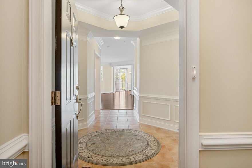 SPACIOUS, well maintained 2 bedroom and 2-bathroom unit, Unit 206 in 327 King farm Blvd, is a corner flat that is 1870 square feet. The elevator in the building makes it easy to access all levels. As you enter the unit, you will notice the spacious foyer that has ceramic tile flooring as well as chair and crown molding. There are large closets that are useful for storing coats and other items. Come into the great room and enjoy the Open Floor Plan. Hardwood floors add to the attractiveness of this space. Walk to the brightly lit sunroom that could be used as an office too, if needed. Pillars accent the entry into the sunroom and dining area. Walkout to the balcony which can easily accommodate outdoor furniture for your wine or coffee oasis. The kitchen with ceramic floors, granite counters, and stainless-steel appliances is ready for the Chef! The primary bedroom has walk-in closets, hardwood flooring and an amazing primary bathroom with a soak in tub, stand up shower and dual sinks. The second bedroom also has walk-in closets and windows that bathe the room in sunshine. The second bathroom in the hallway has a tub in the shower and a linen closet. The washer dryer is conveniently located next to the second bathroom. King Farm is an amazing community with multiple parks, community pool and club house. A free shuttle to Shady Grove Metro station is available to residents. The proximity to mass transportation, Interstate 270, and Inter County connector make this location a commuter’s dream. As per Walk Score, the location has a Walkability Score of 82 and a Bikeable Score of 76. There is a grocery store and various restaurants nearby.