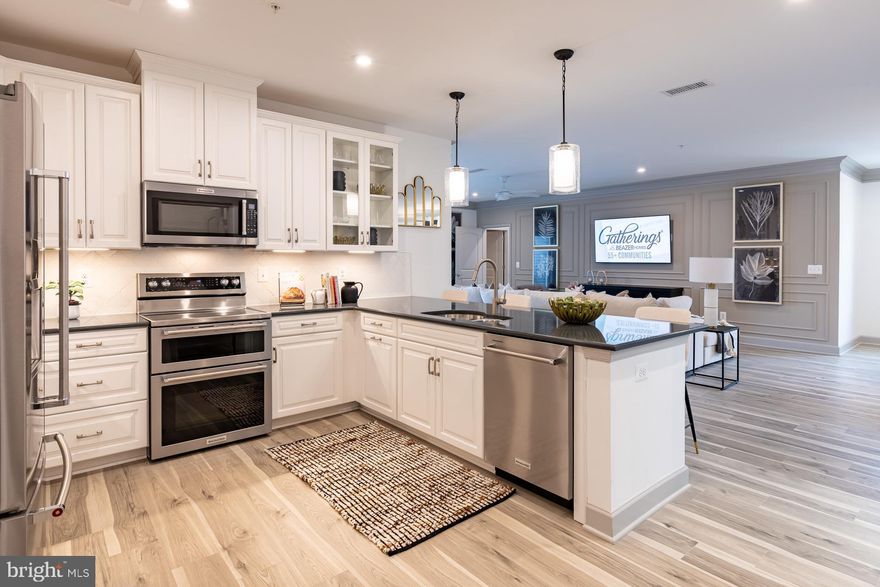 Welcome to the Wiltshire, a beautifully designed single-story condo home in Gatherings at Cabin Branch, Clarksburg’s vibrant 55+ community by Beazer Homes. This spacious new construction offers 3 bedrooms, 2 baths, and an impressive 2,031 sq. ft. of thoughtfully crafted living space. As you enter, a spacious foyer welcomes you—perfect for dropping your bags or shoes and transitioning into the comfort of home. The open-concept layout invites natural light and effortless flow throughout. The modern kitchen features an oversized island, abundant cabinetry, and a walk-in pantry, and it overlooks the expansive living area, creating a seamless space for connection and relaxation. A flexible adjacent space offers room for formal dining or a private den, tailored to your lifestyle. Retreat to your primary suite, complete with a spa-inspired en-suite bath featuring a dual vanity, soaking tub, walk-in shower, and a generous walk-in closet. Two additional bedrooms provide versatility for guests, hobbies, or a home office. Enjoy peaceful mornings or relaxing evenings on your private balcony and take advantage of the walk-in laundry room for everyday ease. Located in a controlled-access building, residents enjoy exclusive amenities like a billiards room, movie theatre, golf simulator, and more. Additional highlights include a 1-car garage and valet trash service three times a week. Plus, enjoy access to the clubhouse, fitness room, community gardens, and nearby Clarksburg Premium Outlets for shopping and dining. Don’t miss your chance to live the lifestyle you’ve earned. Special buyer incentives may include closing cost assistance—schedule your appointment today and make the Wiltshire your new home.