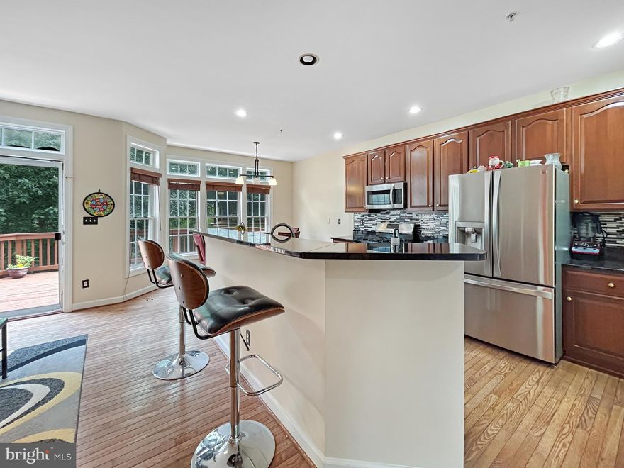 Welcome to this beautiful 3-bedroom, 2 full and 2 half bath townhome with a one-car garage, offering spacious and stylish living across three finished levels.

Step into an expansive open-concept living and dining area adorned with elegant moldings and a charming bay window that fills the space with natural light. The gourmet kitchen is a chef’s dream, featuring rich cherry cabinetry, granite countertops, a center island with breakfast bar, and a cozy breakfast nook with French doors that open to a private deck—perfect for morning coffee or evening relaxation.

Upstairs, you'll find a generous primary suite complete with a walk-in closet and full bath, along with two additional bedrooms and a second full bathroom. The finished walkout basement offers a large rec room, a convenient half bath, laundry area, ample storage, and access to the finished garage.

Enjoy resort-style living in this vibrant golf course community—don’t miss your chance to call this stunning townhome your next home!